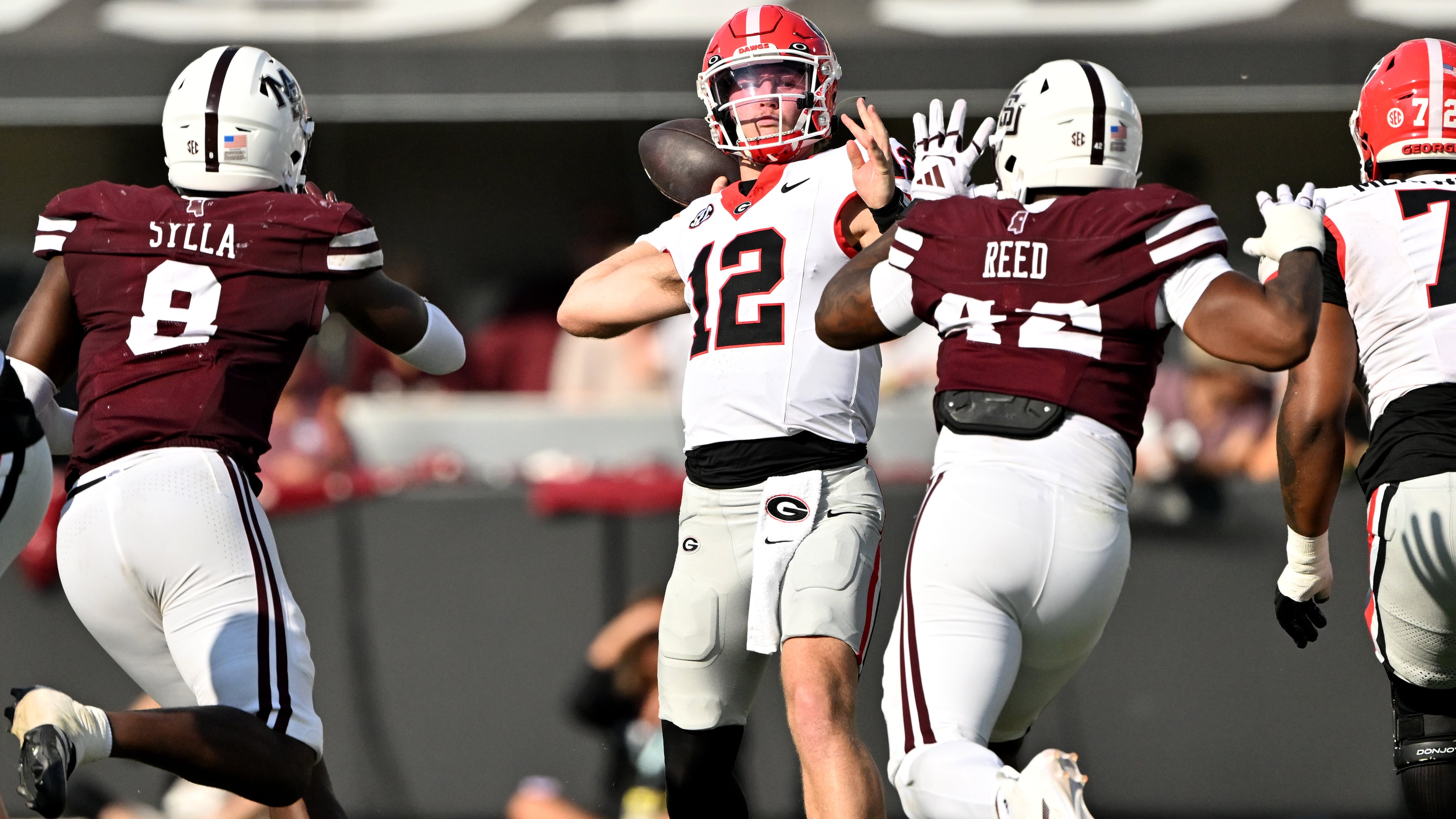Georgia quarterback Ryan Puglisi (center) gets off a pass during the second half of a game against Mississippi State at Davis Wade Stadium, Saturday, Nov. 8, 2025, in Starkville, Mississippi. (Hyosub Shin/AJC)