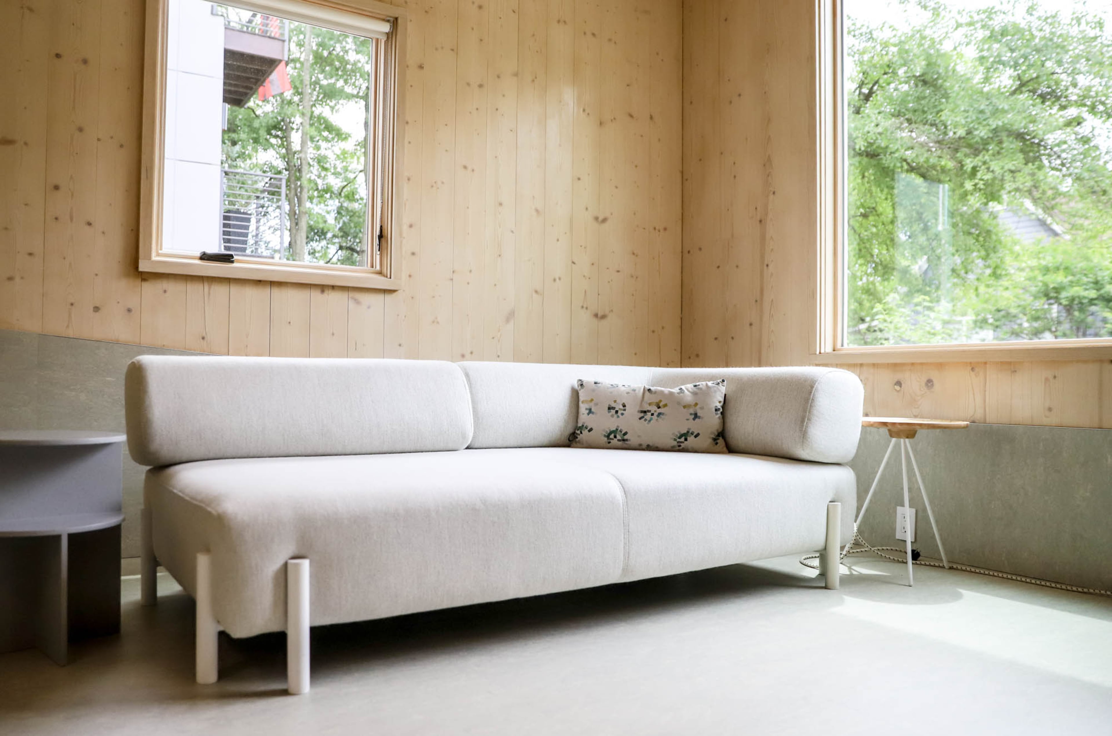 The contemporary interiors include the Palo two-seater chaise in chalk and the Key side table in lacquered ash and white, both by Hem Design Studio. Muuto's Halves side table is designed by Jessica Nakanishi and Jonathan Sabine of M-S-D-S Studio. The Colorwheel textile for the pillow is part of Hella Jongerius' collection with Maharam.