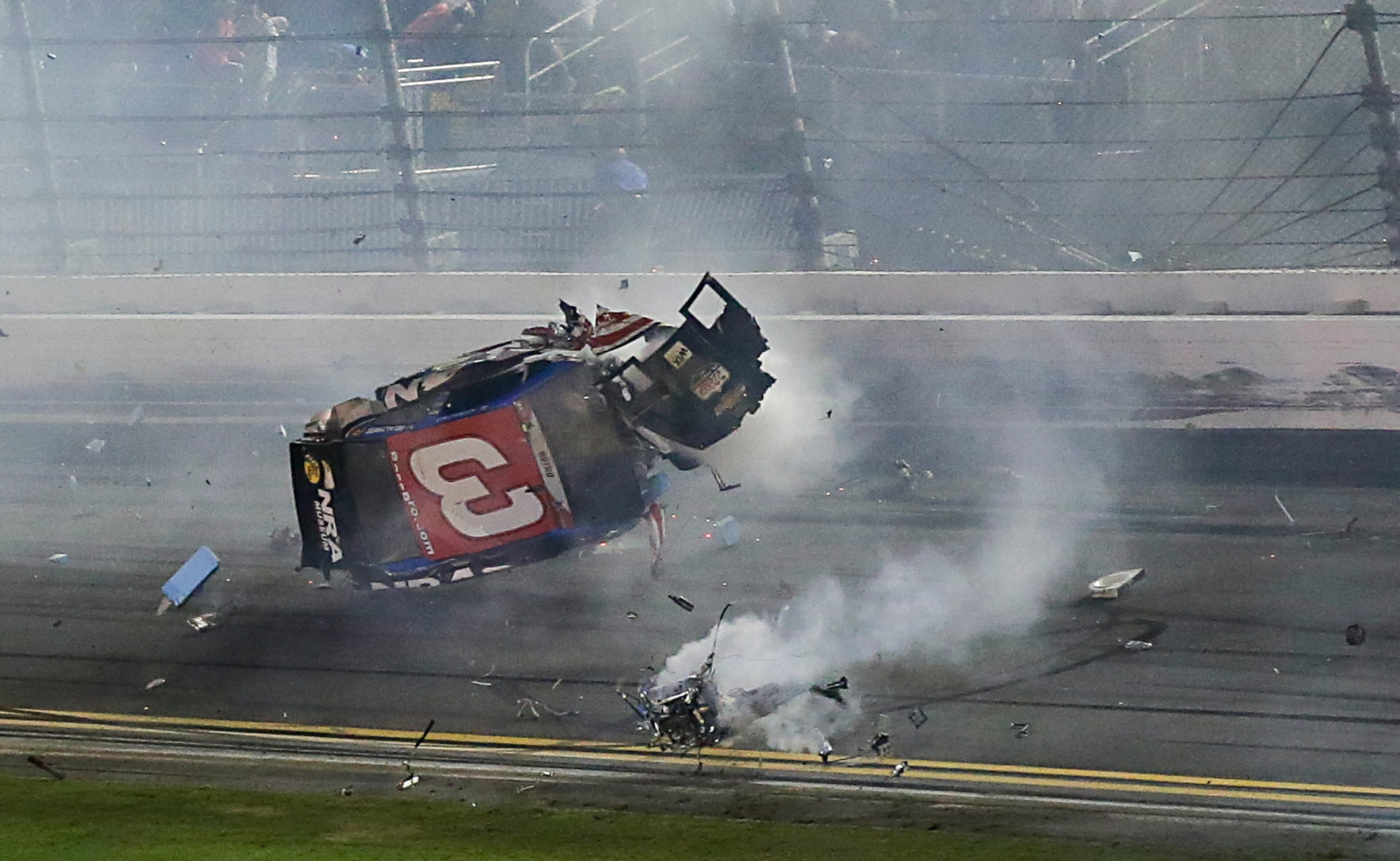 Austin Dillon tumbles down the backstretch after he was involved in a multi-car crash on the final lap of a NASCAR Sprint Cup series auto race at Daytona International Speedway, Monday, July 6, 2015, in Daytona Beach, Fla. (AP Photo/Terry Renna)