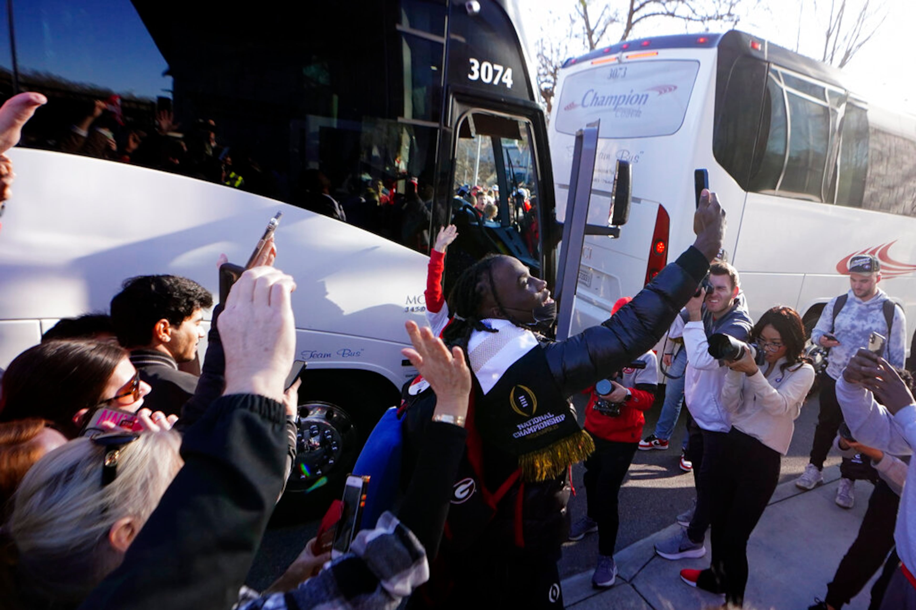 Georgia defensive back Kelee Ringo takes a selfie as he is greeted by a large crowd of fans upon his return to the Georgia campus, Tuesday, Jan. 11, 2022, in Athens, Ga., after defeating Alabama in the College Football Championship NCAA college football game. (AP Photo/John Bazemore)