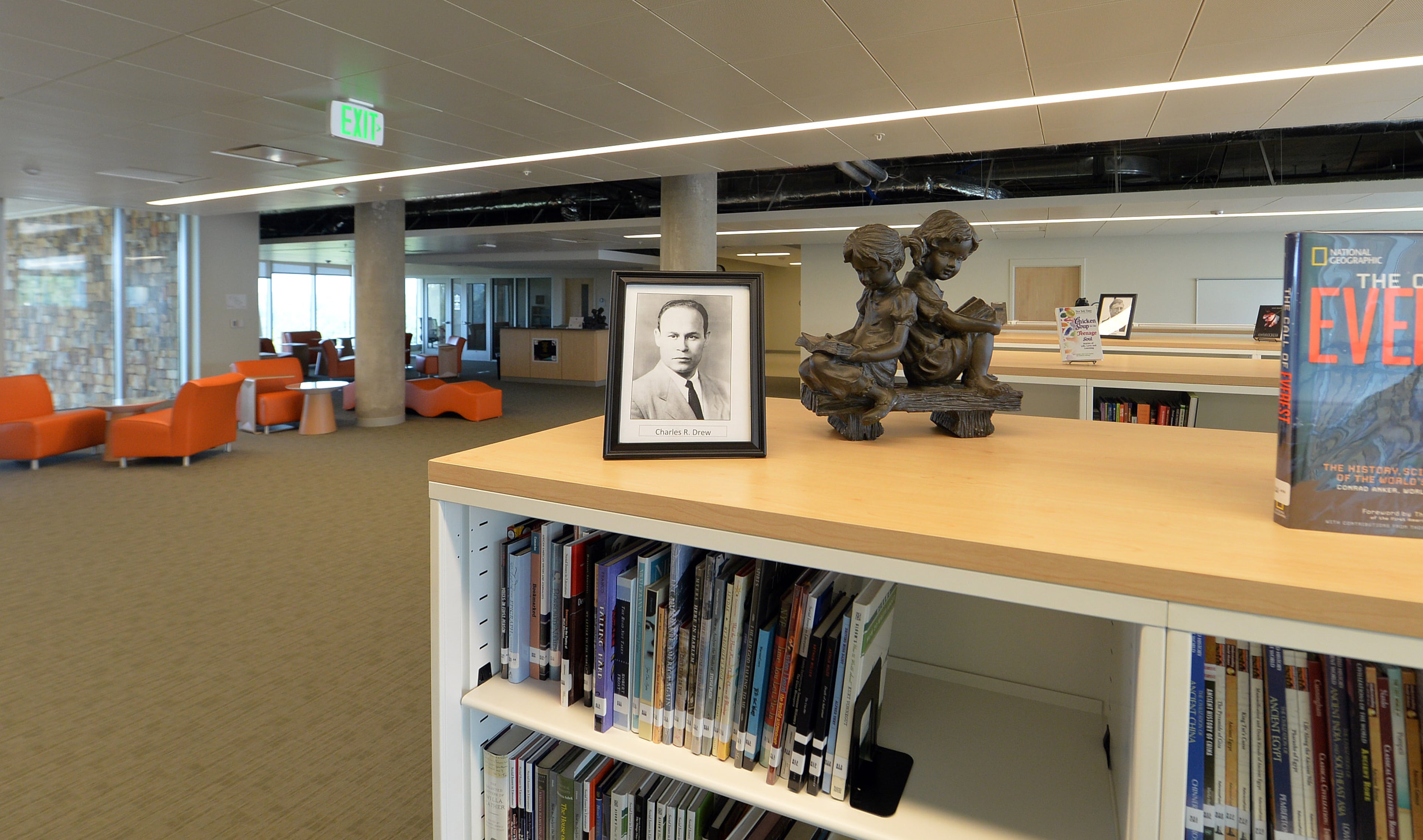 The media center area features portraits of the school's namesake, Dr. Charles R. Drew.