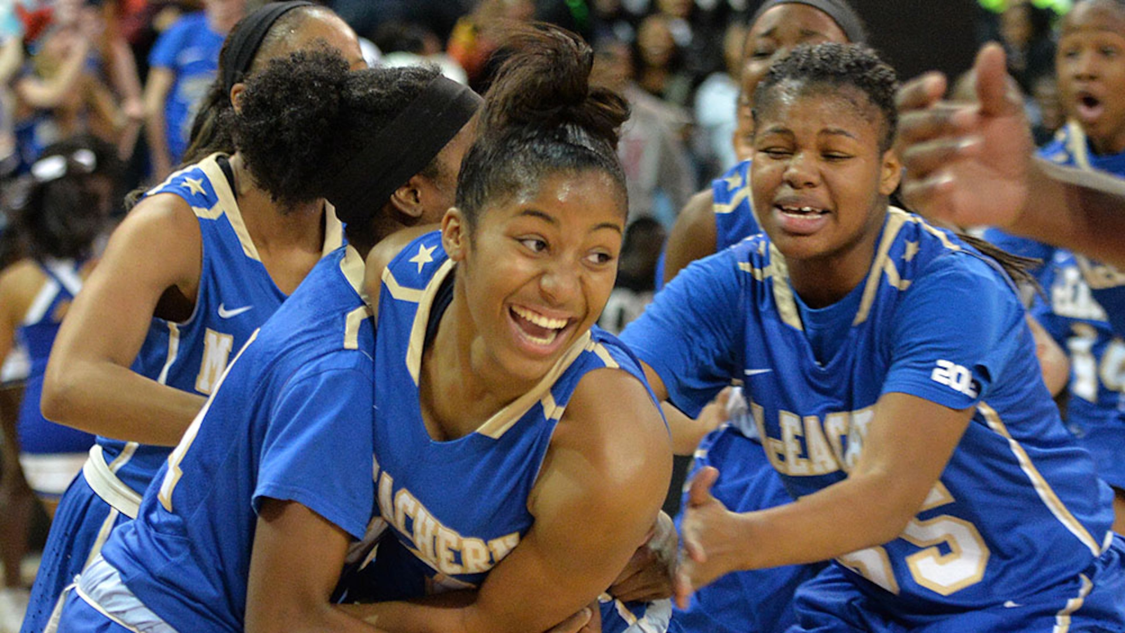 February 28, 2015 Atlanta - McEachern's Te'a Cooper (2) is celebrated by teammates after she scored the game wining goal to beat 59-57 over Archer at the end of 4th quarter at McCamish Pavilion in Georgia Tech campus on Saturday, February 28, 2015. McEachern defeated Archer 59-57 in the Class AAAAAA high school basketball tournament. HYOSUB SHIN / HSHIN@AJC.COM McEachern's Te'a Cooper (2) is celebrated by teammates after she scored the game-wining shot in the Class AAAAAA tournament. (Hyosub Shim / AJC)