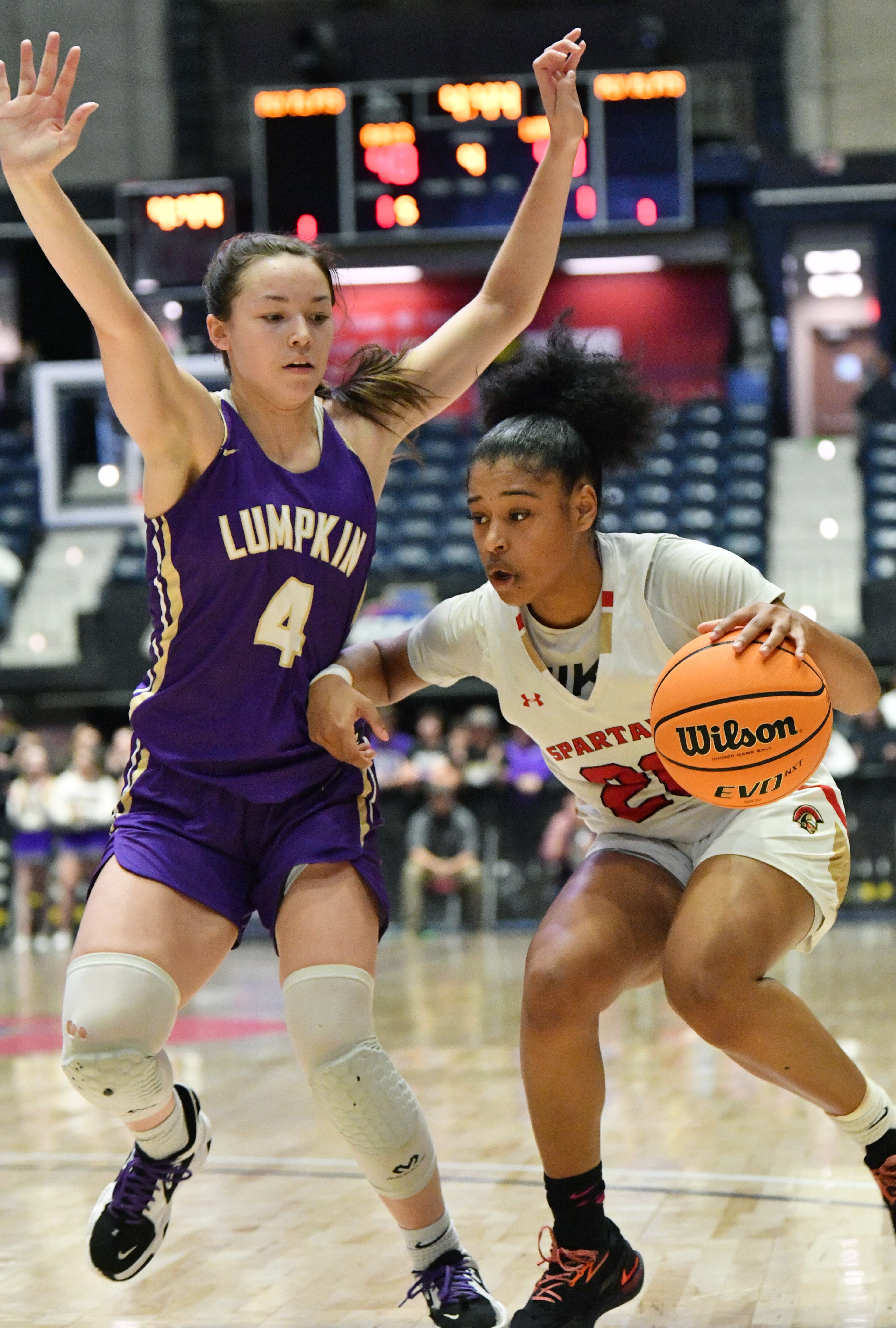 March 11, 2022 Macon - Greater Atlanta Christian's Kaleigh Addie (20) drives against Lumpkin County's Averie Jones (4) during the 2022 GHSA State Basketball Class AAA Girls Championship game at the Macon Centreplex in Macon on Friday, March 11, 2022. (Hyosub Shin / Hyosub.Shin@ajc.com)