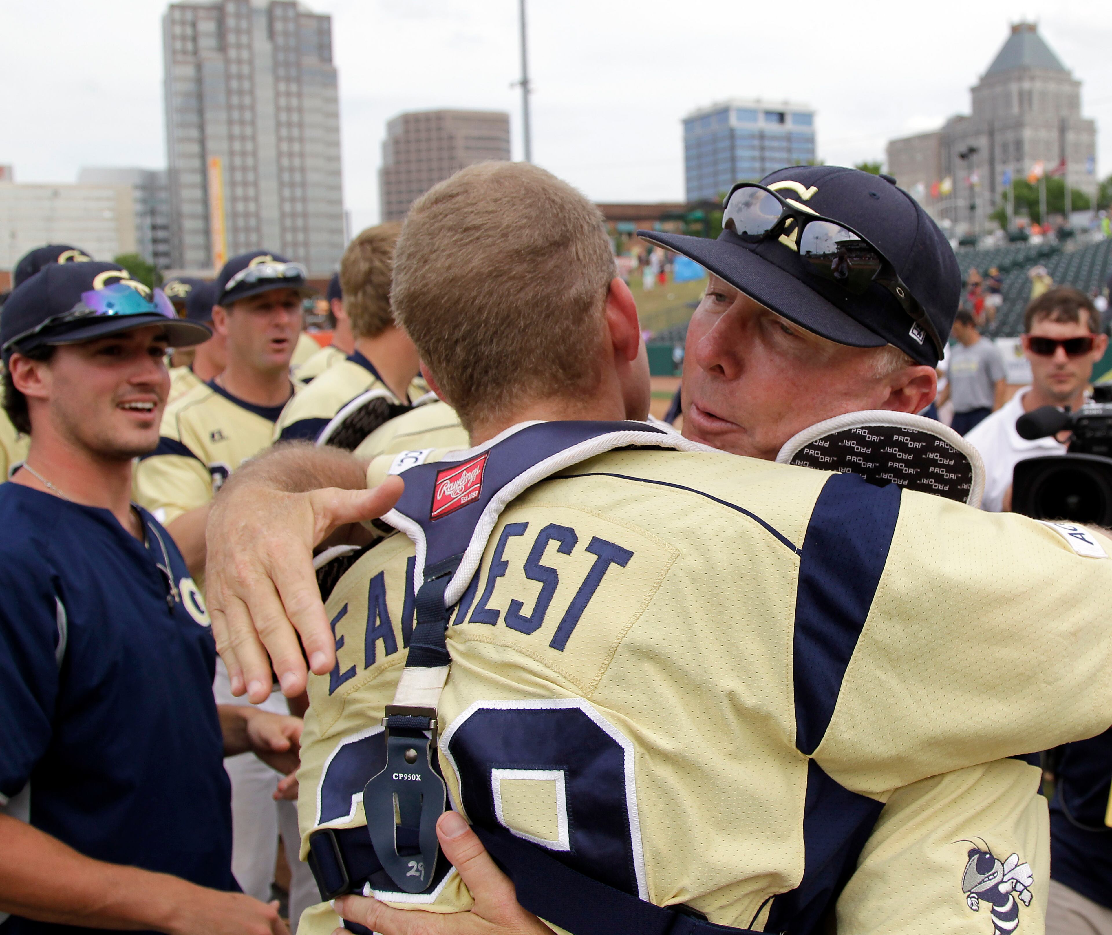 Georgia Tech head coach Danny Hall hugs his catcher Mitch Earnest (29) after they beat Maryland 9-4 to win the championship game of the Atlantic Coast Conference baseball tournament in Greensboro, N.C., Sunday, May 25, 2014. (AP Photo/Bob Leverone)