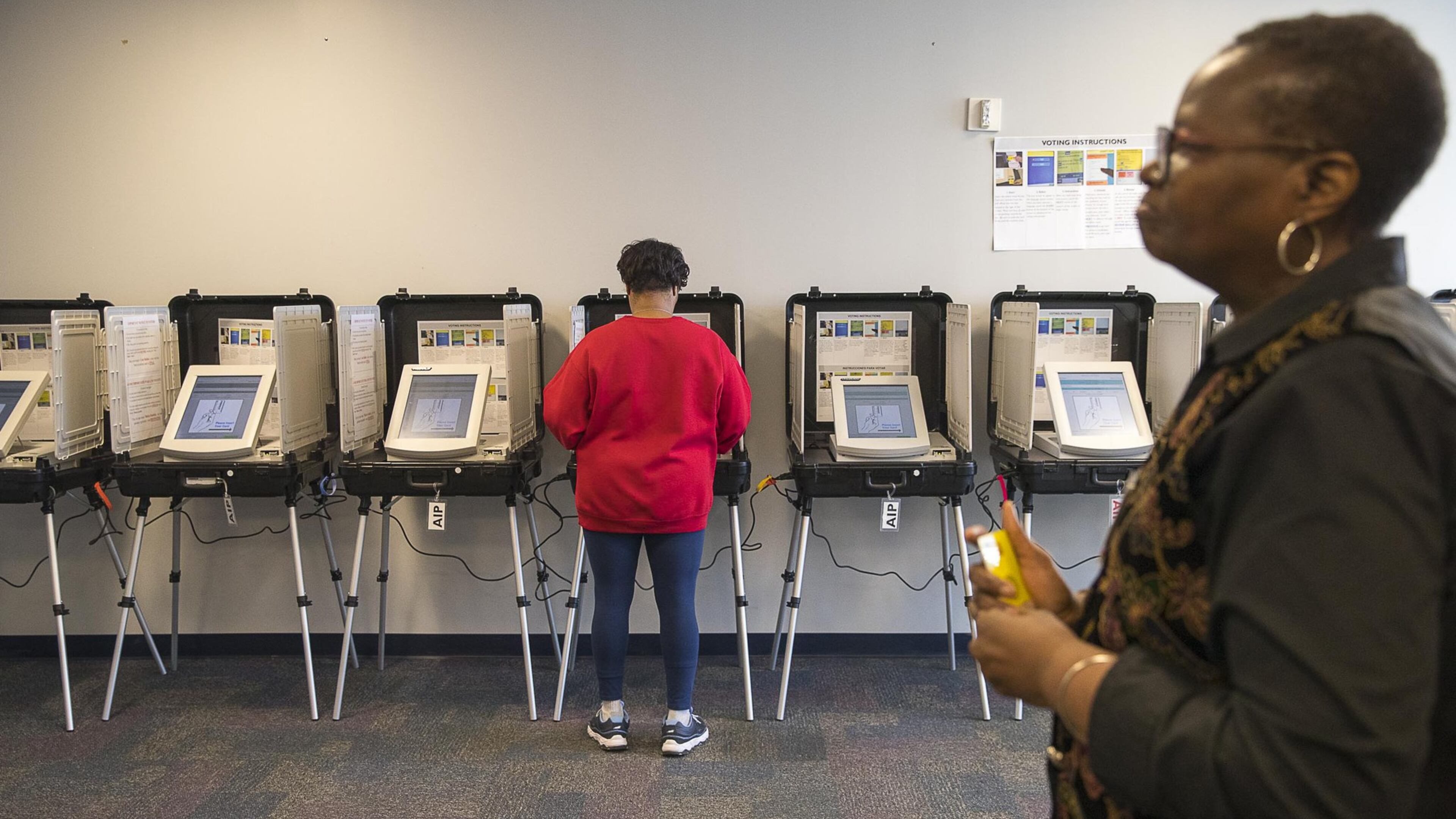 A Gwinnett County resident participates in early voting at the Gwinnett County Board of Voter Registration and Elections Building in Lawrenceville in February. (ALYSSA POINTER/ALYSSA.POINTER@AJC.COM)