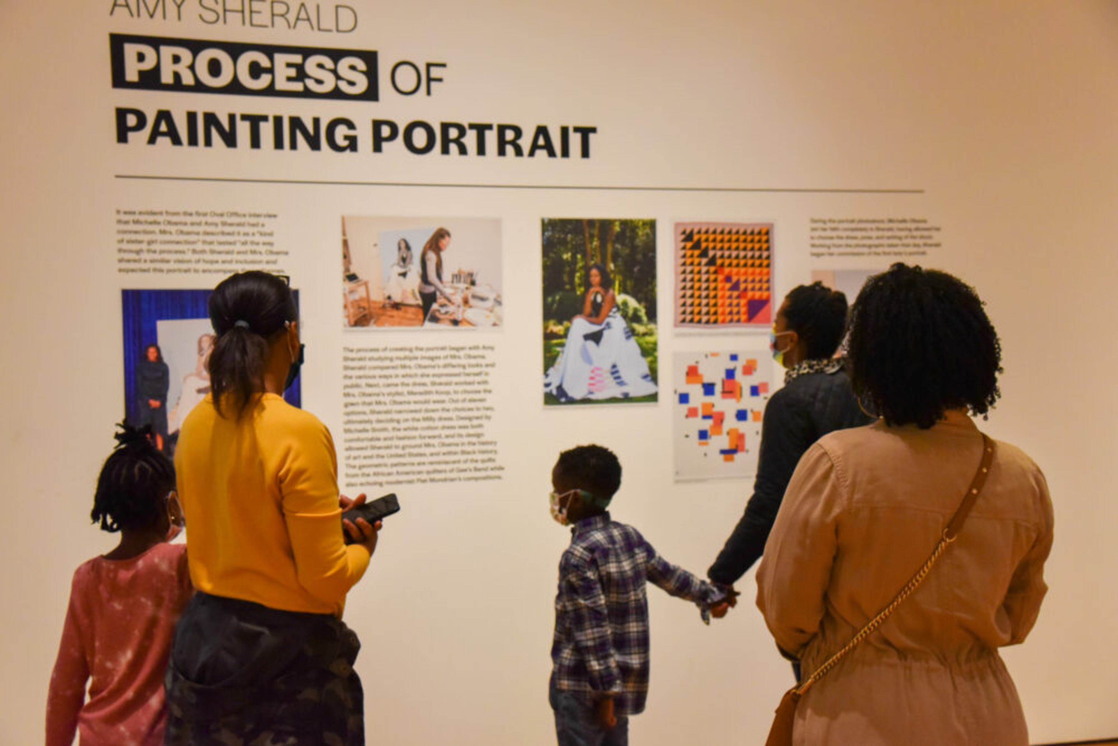 A group of people viewing the process of making the Obama portraits at the High Museum