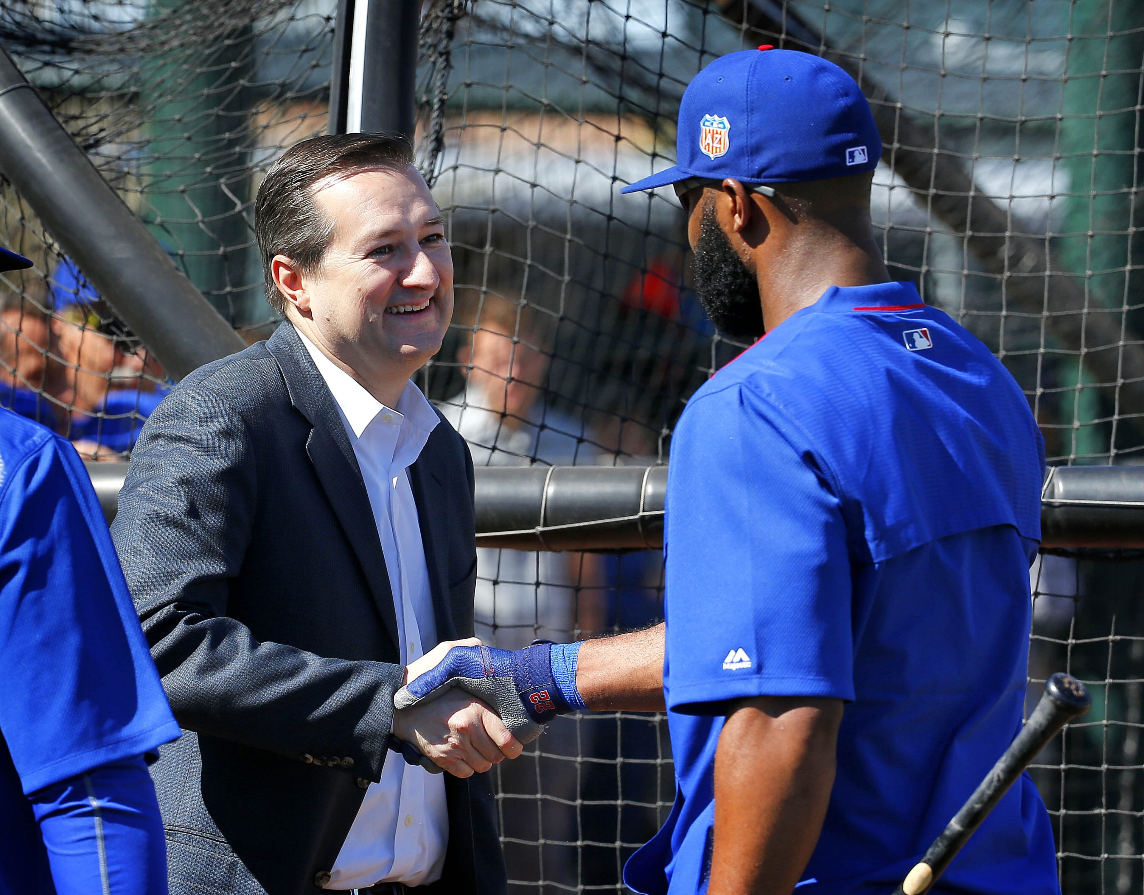Chicago Cubs owner Tom Ricketts, left, greets Jason Heyward during spring training baseball practice, Wednesday, Feb. 24, 2016, in Mesa, Ariz. (AP Photo/Matt York)