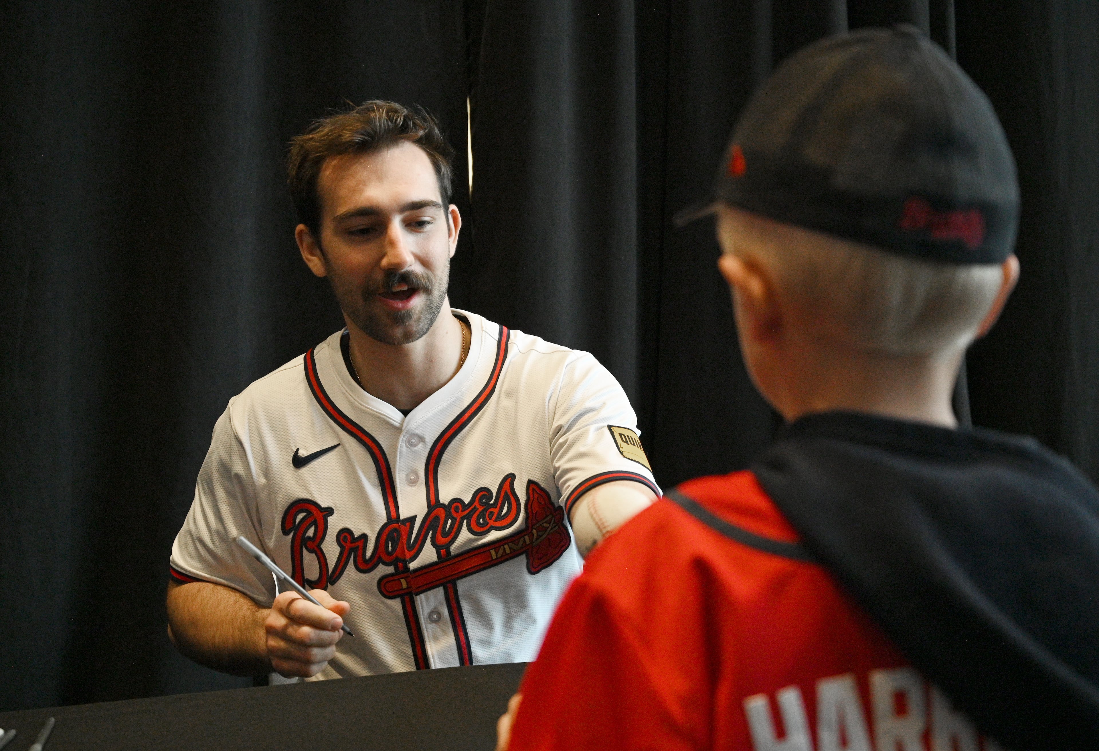 Atlanta Braves starting pitcher Spencer Strider signs an autograph for a fan during 2024 Braves Fest at Truist Park, Saturday, January 27, 2024, in Atlanta. (Hyosub Shin / Hyosub.Shin@ajc.com)