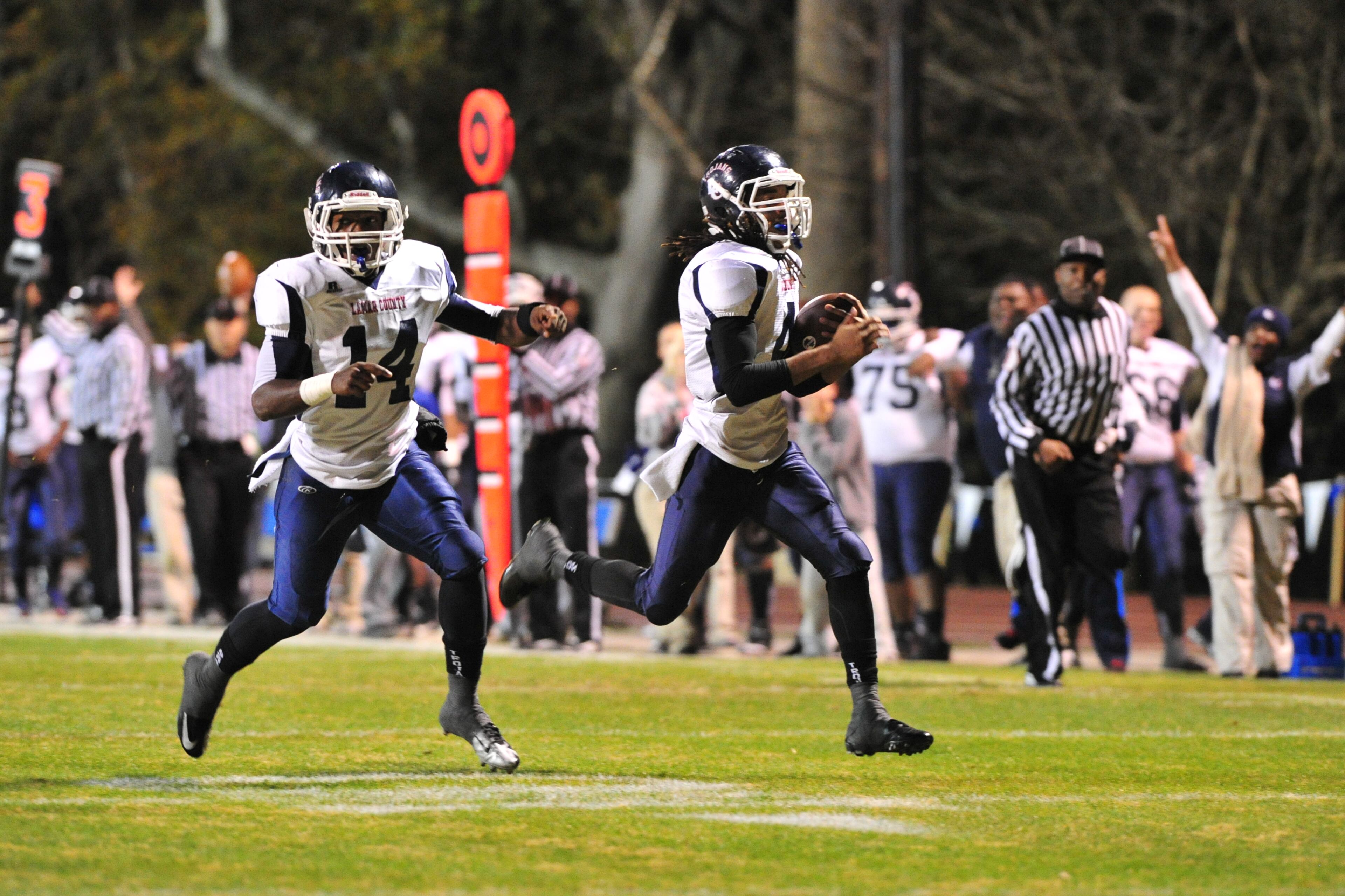 The Lovett Lions (8-4) played the Lamar County Trojans (11-0-1) in the Quarterfinal round of the 2012 GHSA AA State Playoffs. Lamar County senior RB Antwan Wallace scores the Trojans first TD of the game. He is escorted to the end zone by junior QB Lance Austin. PERRY McINTYRE / SPECIAL