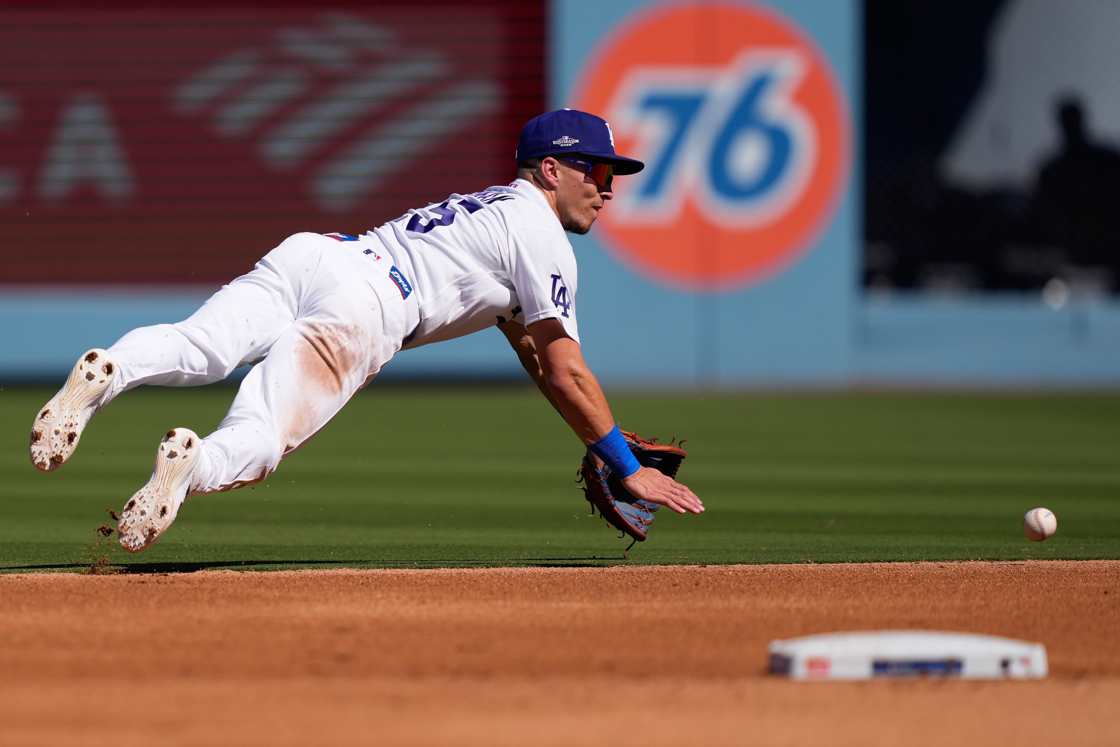 Los Angeles Dodgers second baseman Tommy Edman fields a ball before throwing to first for the out on Atlanta Braves' Ronald Acuña Jr. during the fourth inning of Game 1 of a National League Division Series baseball game Saturday, Oct. 3, 2026, in Los Angeles. (Mark J. Terrill/AP)