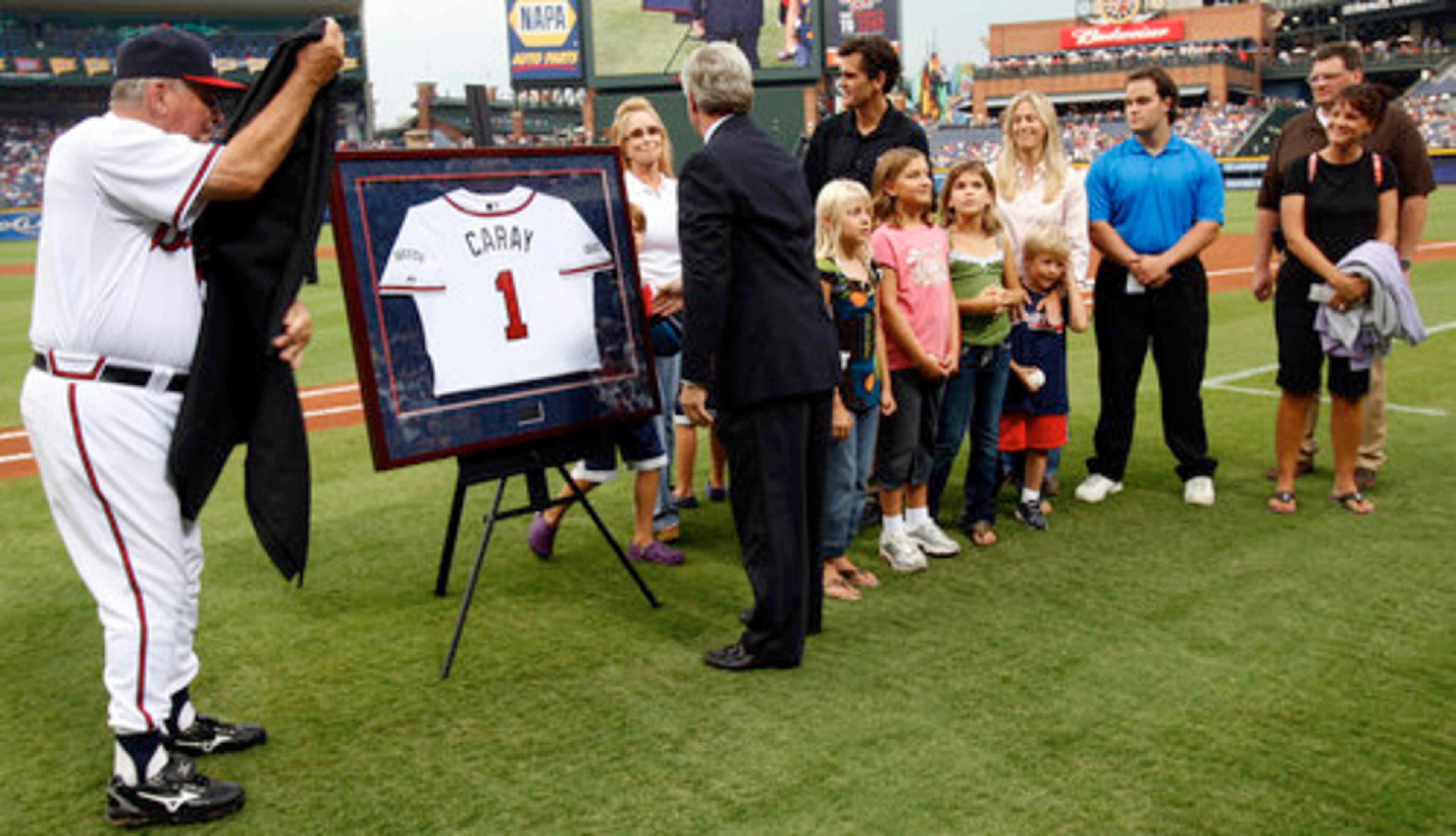 Braves manager Bobby Cox (left) and GM Frank Wren present Skip Caray's family with a special jersey during a ceremony honoring the late broadcaster before Wednesday night's game at Turner Field.