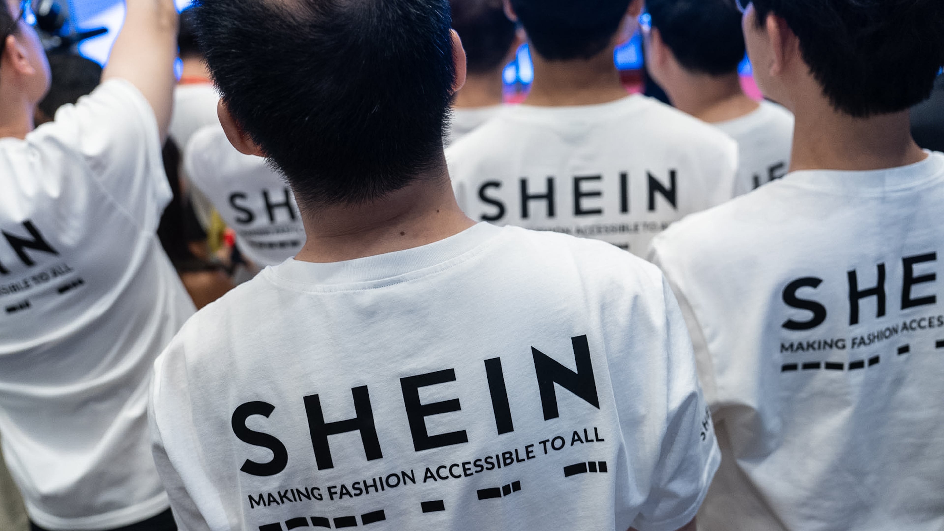 A logo of fast-fashion retailer Shein is seen on the t-shirt at the listing ceremony in Hong Kong, Tuesday, Sept. 1, 2026. (AP Photo/Chan Long Hei)