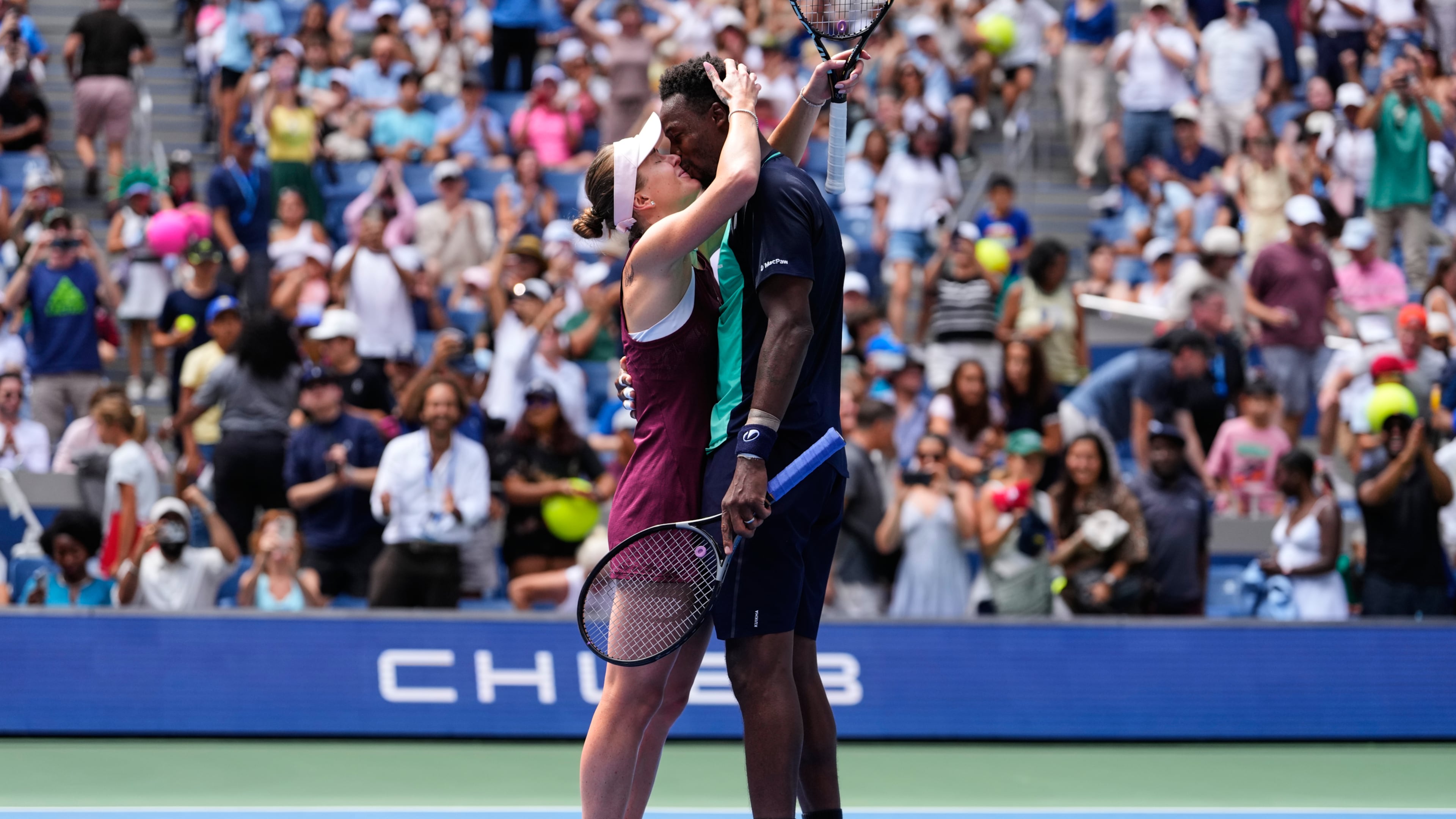 Elina Svitolina, of Ukraine, left, and Gael Monfils, of France, kiss after winning a mixed doubles match at the U.S. Open tennis championships, Tuesday, Aug. 25, 2026, in New York. (AP Photo/Yuki Iwamura)