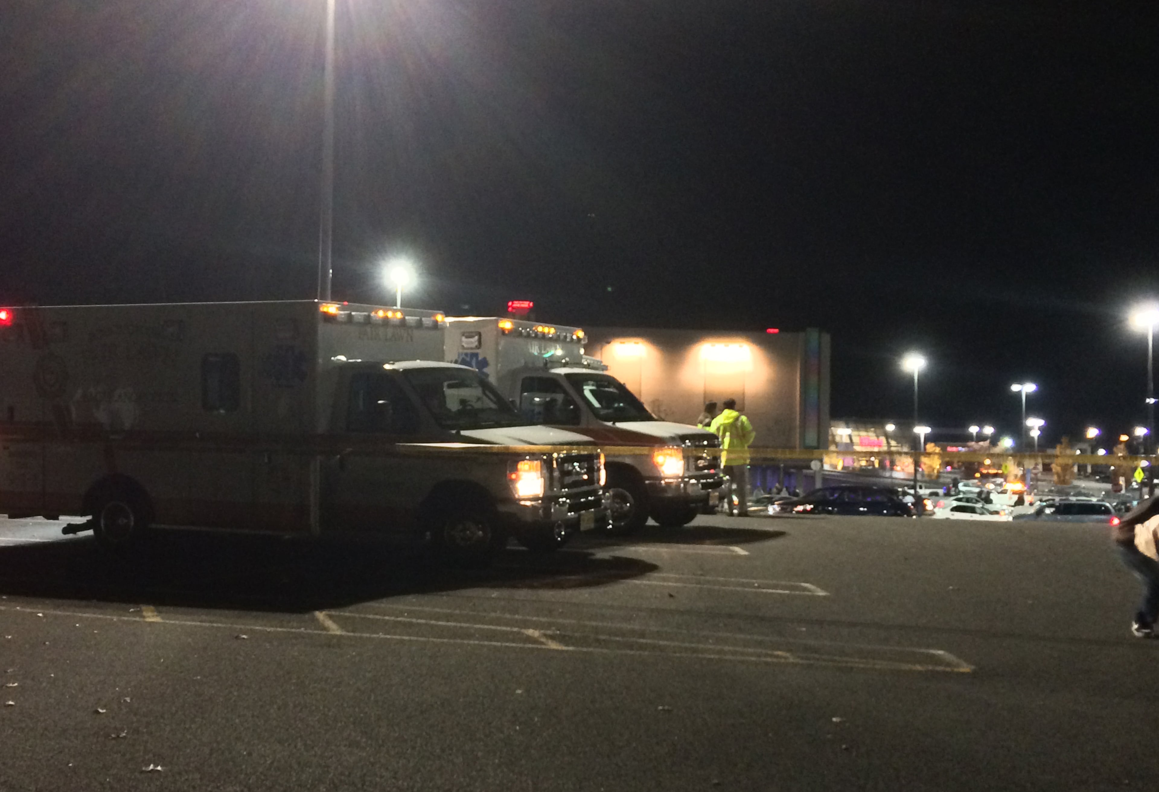 In this photo taken and provided to the AP, which has been authenticated based on its contents and other AP reporting, medical personnel wait in the parking lot of Garden State Plaza Mall, late Monday, Nov. 4, 2013, in Paramus, N.J., after there were reports of multiple shots being fired inside the mall. There were no reports of fatalities or injuries late Monday. (AP Photo/Carlos Sinde)
