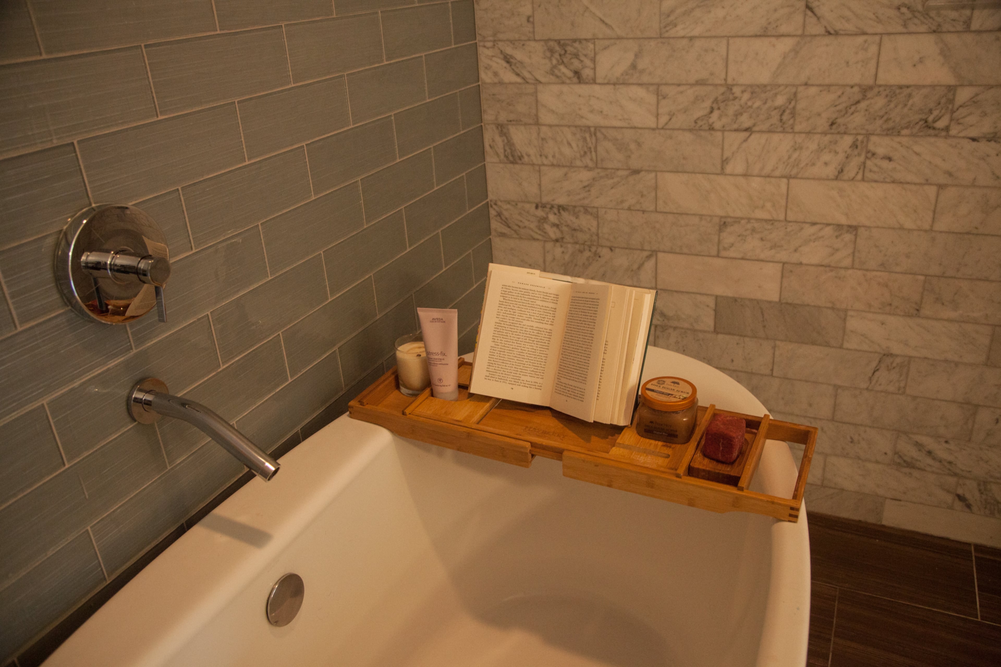 An soaking tub is surrounded by marble tile in the renovated master bathroom. The original tub sat on a rectangular platform, the homeowners said.