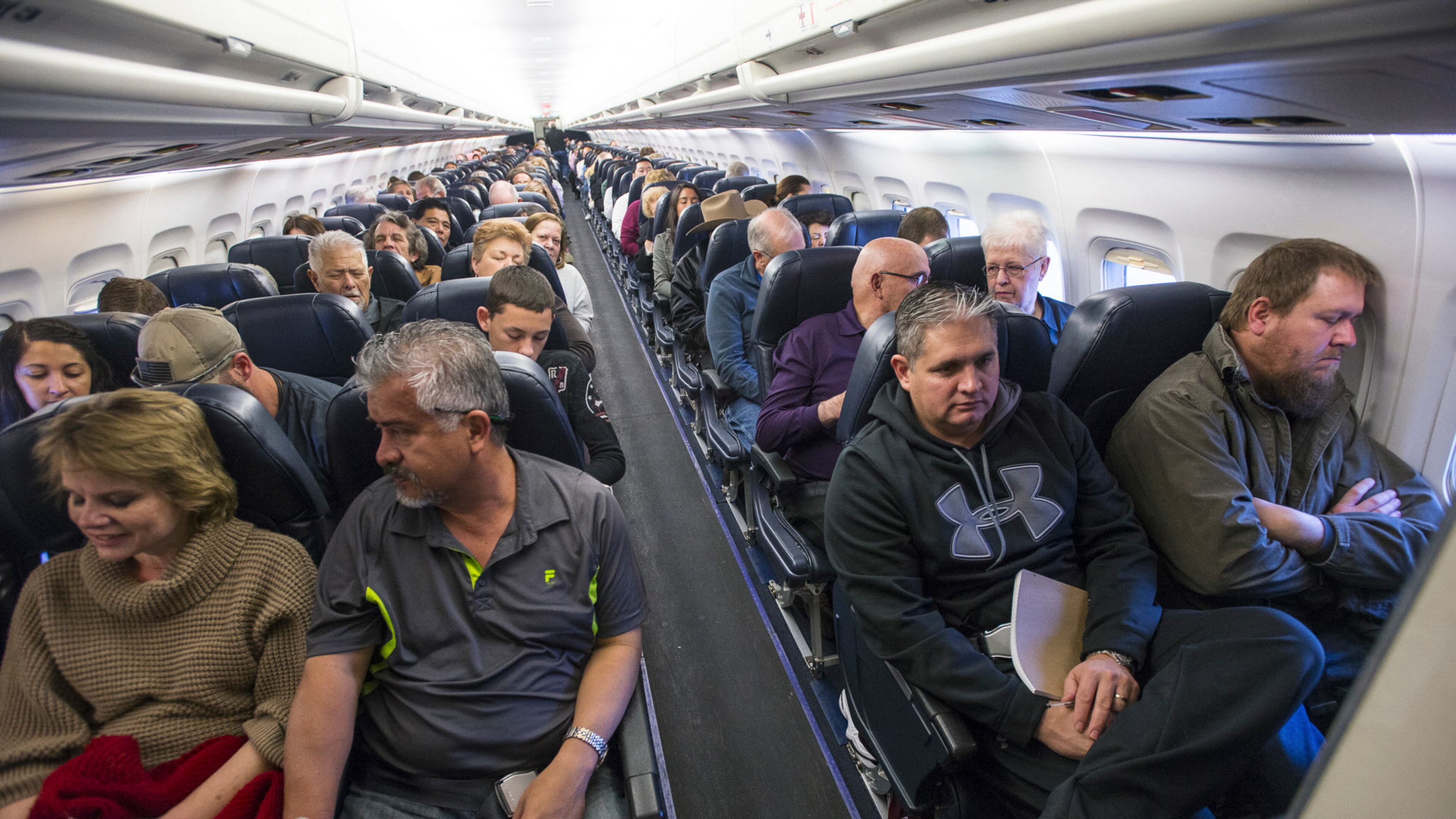 Passengers on a flight in Las Vegas. (Joe Giron/The New York Times)
