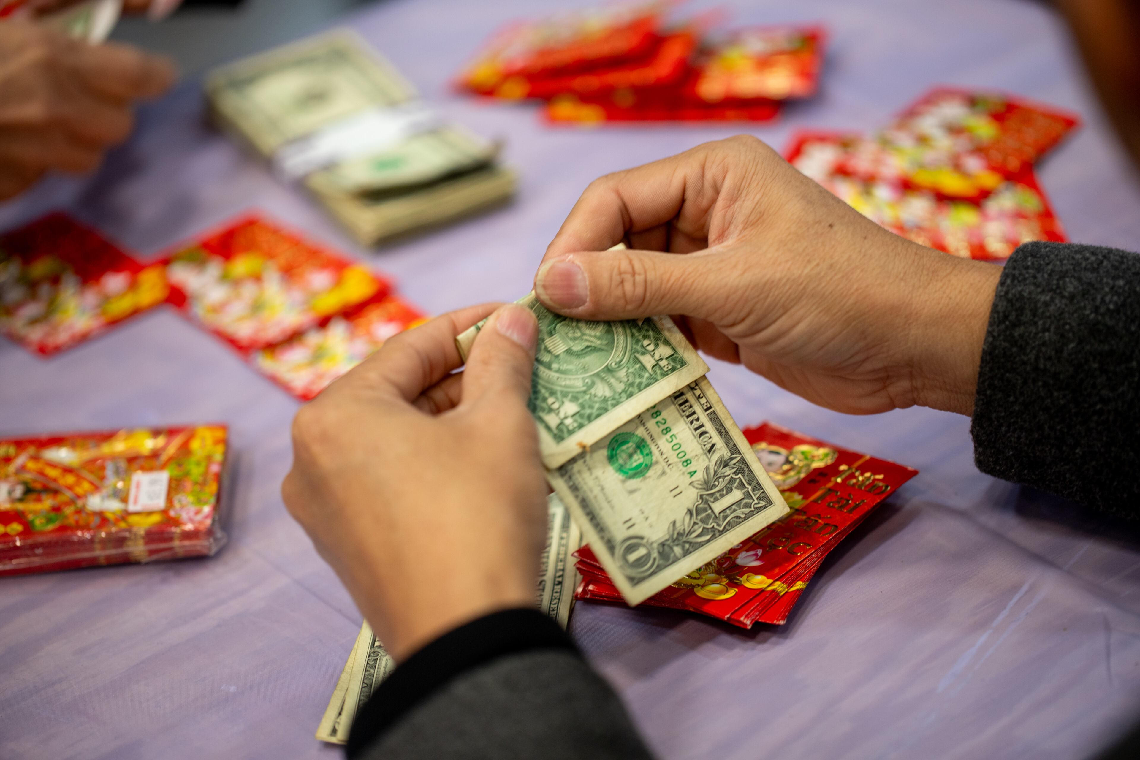 The Vietnamese American Community of Georgia hosts a Lunar New Year celebration at Plaza Las Americas where lucky money is tucked into envelopes to give away in Lilburn on Saturday, Feb 3, 2024 where dragon and lion dancing begins the weekend. The celebration continues on Sunday and includes traditional food, music and cultural festivities. (Jenni Girtman for The Atlanta Journal-Constitution)
