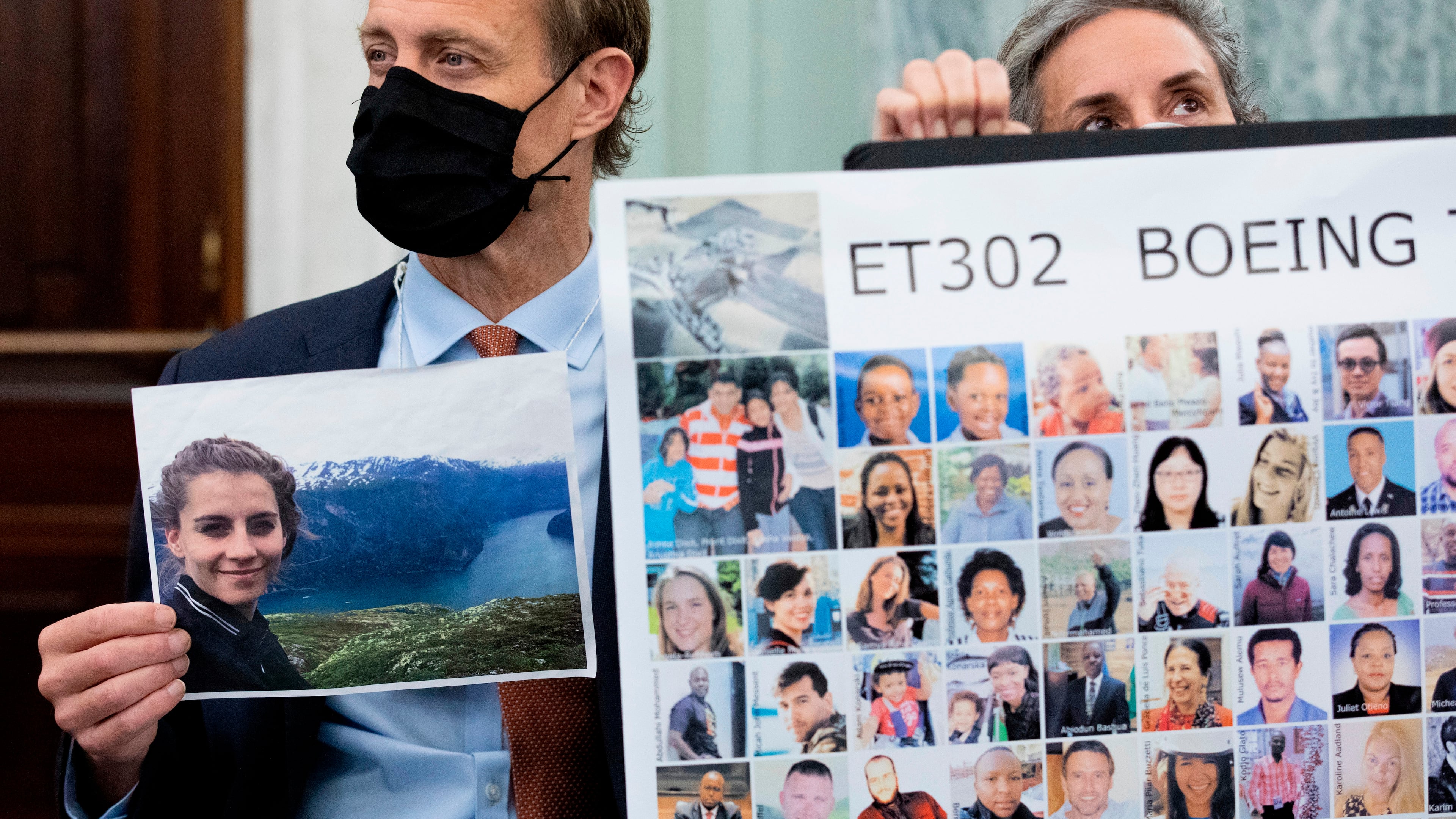 FILE - Michael Stumo, holding a photo of his daughter Samya Stumo, and his wife Nadia Milleron, sit behind FAA Administrator Steve Dickson during a Senate Committee on Commerce, Science, and Transportation hearing on the implementation of aviation safety reform at the U.S. Capitol in Washington, Nov. 3, 2021. (AP Photo/Amanda Andrade-Rhoades, File)