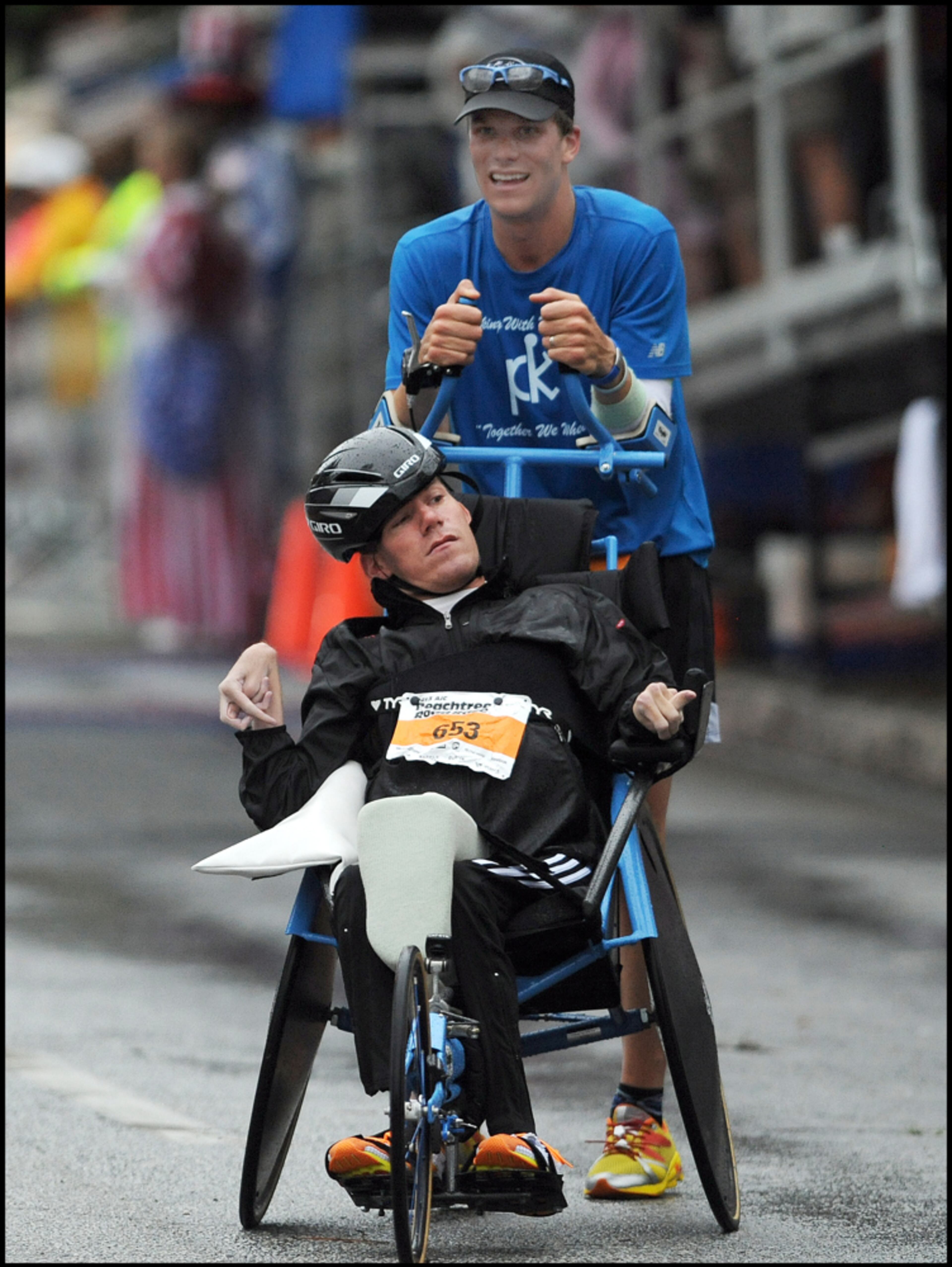 July 4, 2013 -ATLANTA: This was the best photo I took this year that showed a special bond between brothers. Brent Pease, 30, pushes his brother,Kyle Pease,28, to the finish line during the AJC Peachtree Road Race on Thursday, July 4, 2013 at Piedmont Park. Camera Nikon D3, Lens 300mm f2.8, ISO 1000, Aperture f3.2, Shutter speed 1/1000. JOHNNY CRAWFORD / JCRAWFORD@AJC.COM