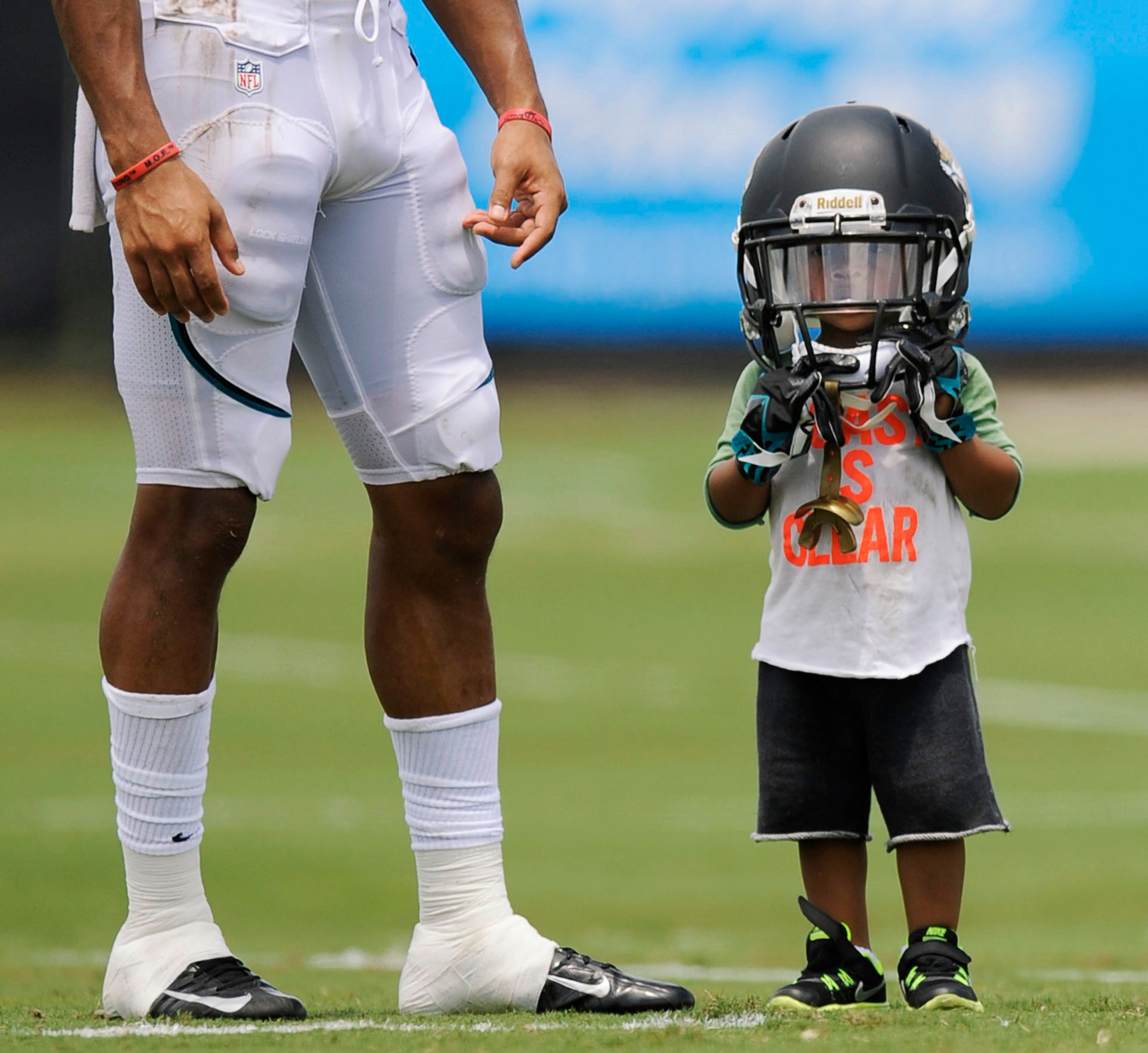 Cecil Shorts IV, 2, sports his father Jacksonville Jaguars' Cecil Shorts III's helmet during NFL football training camp Wednesday, July 31, 2013. (AP Photo/The Florida Times-Union, Bob Self)