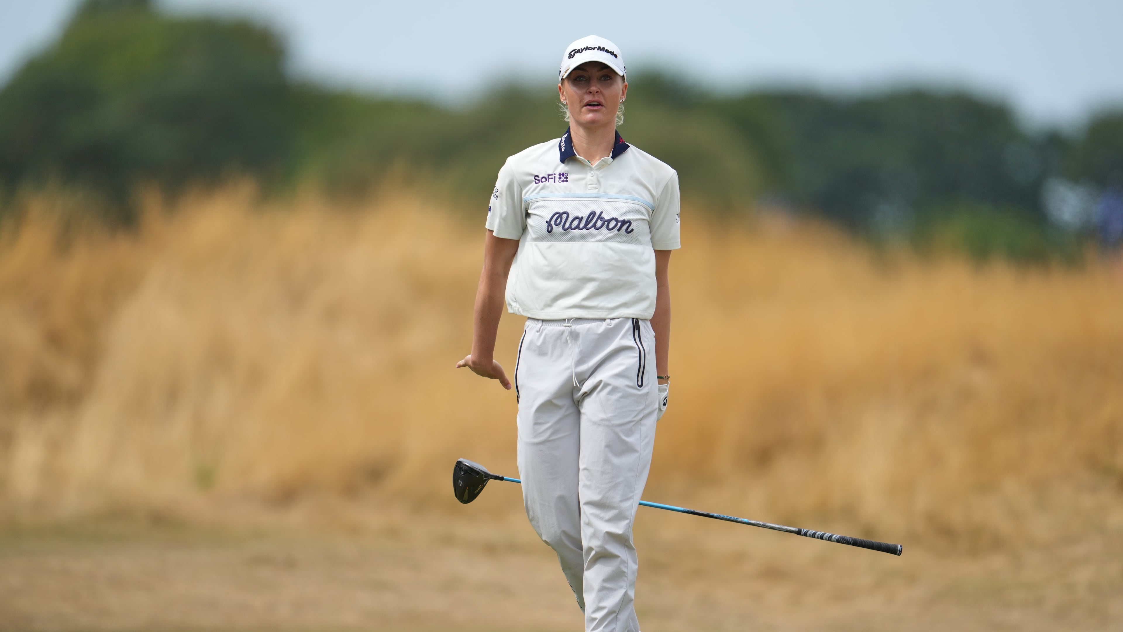 Charley Hull, of England, drops her club after driving off the 3rd tee during the fourth round of the Women's British Open golf championship in Lytham St Annes, England, Sunday, Aug. 2, 2026. (AP Photo/Jon Super)