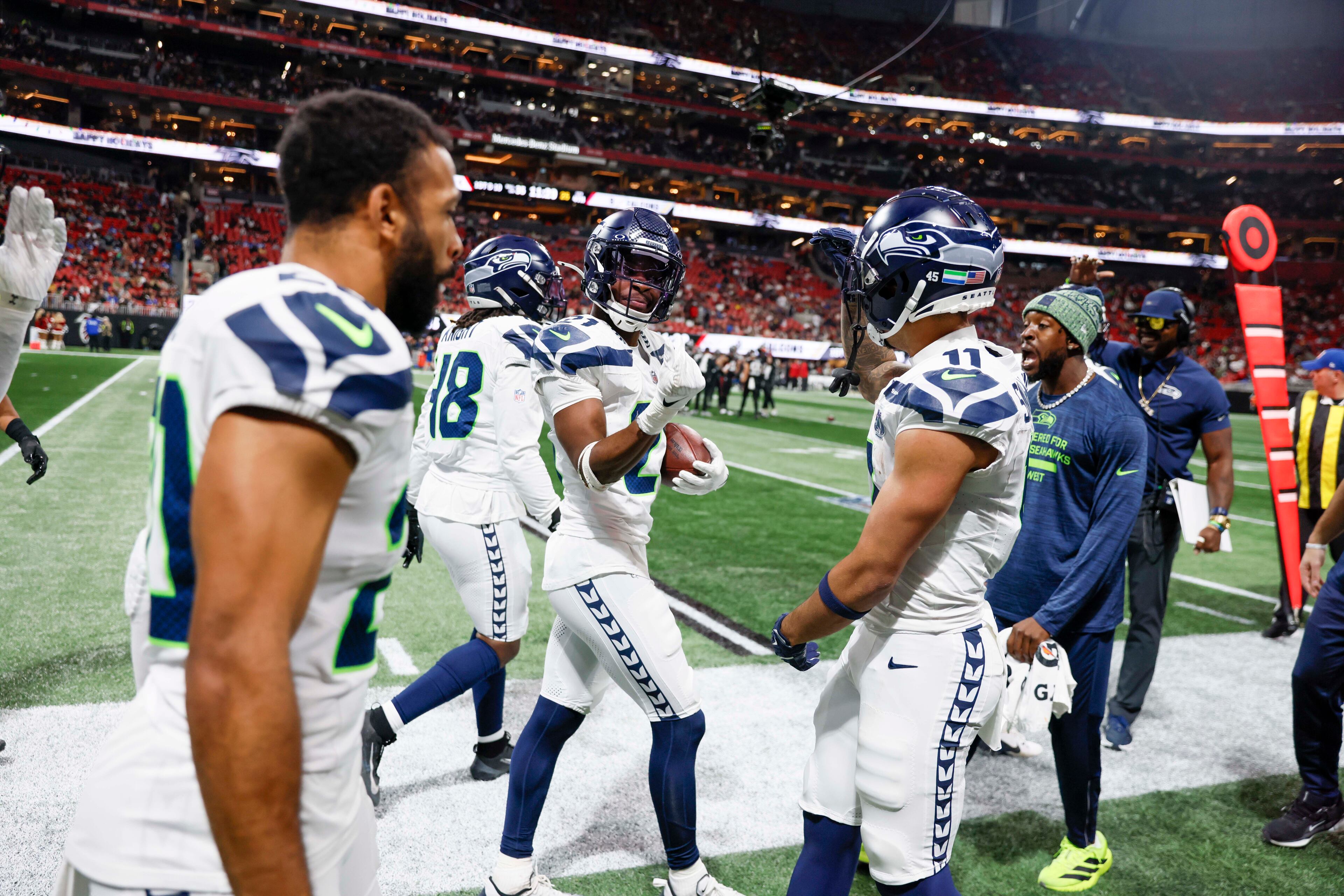 Seattle Seahawks cornerback Devon Witherspoon (21), center, reacts with teammates after intercepting during the second half of an NFL game against the Atlanta Falcons at Mercedes-Benz Stadium in Atlanta on Sunday, Dec. 7, 2025. (Miguel Martinez/ AJC)