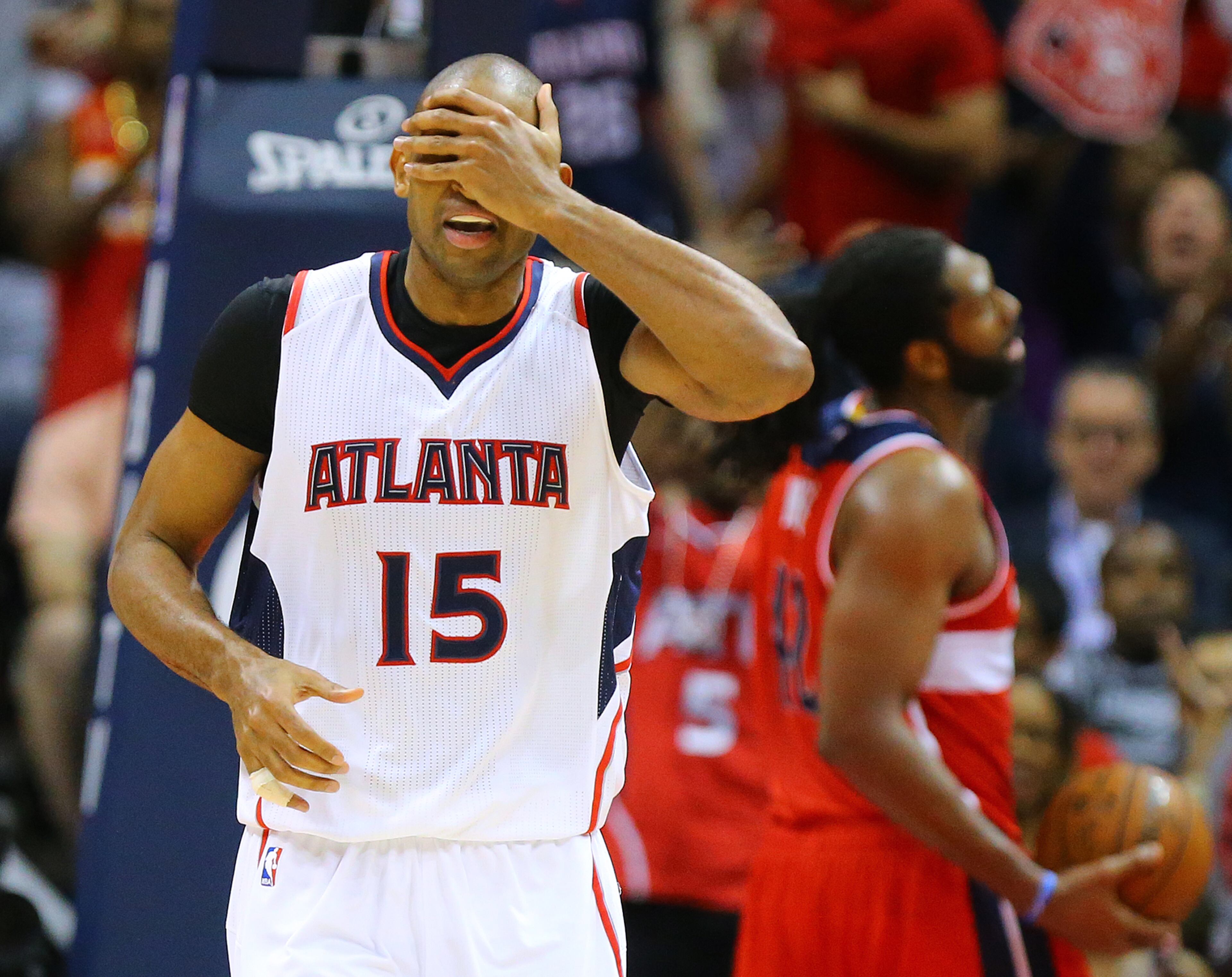 Hawks center Al Horford covers his face after making a shot against the Wizards on Tuesday, May 5, 2015. Curtis Compton / ccompton@ajc.com