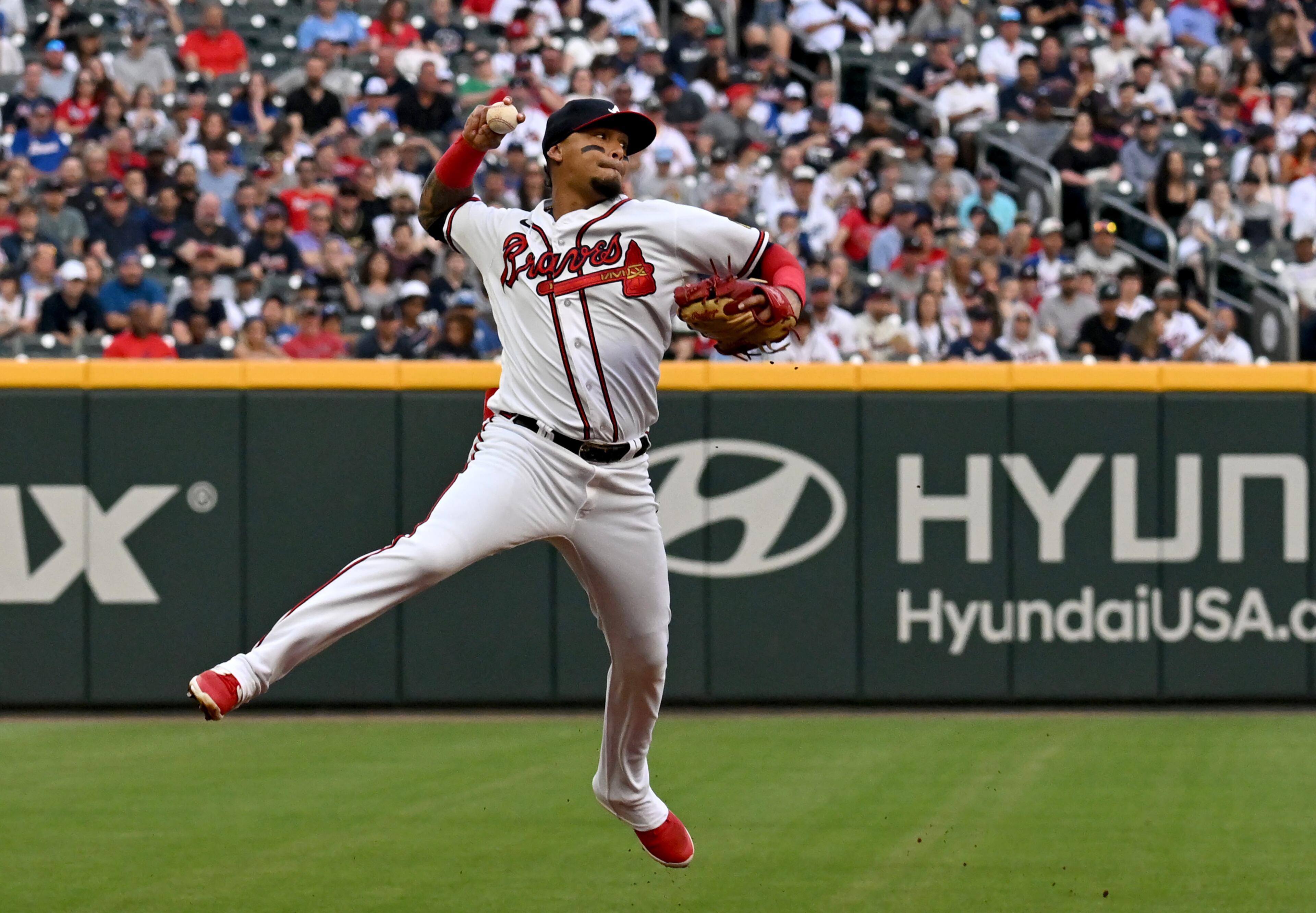 Atlanta Braves' shortstop Orlando Arcia (11) throws to the first base but can't retire the Los Angeles Dodgers' Miguel Vargas (17) during the second inning at Truist Park, Wednesday, May 24, 2023, in Atlanta. (Hyosub Shin / Hyosub.Shin@ajc.com)
