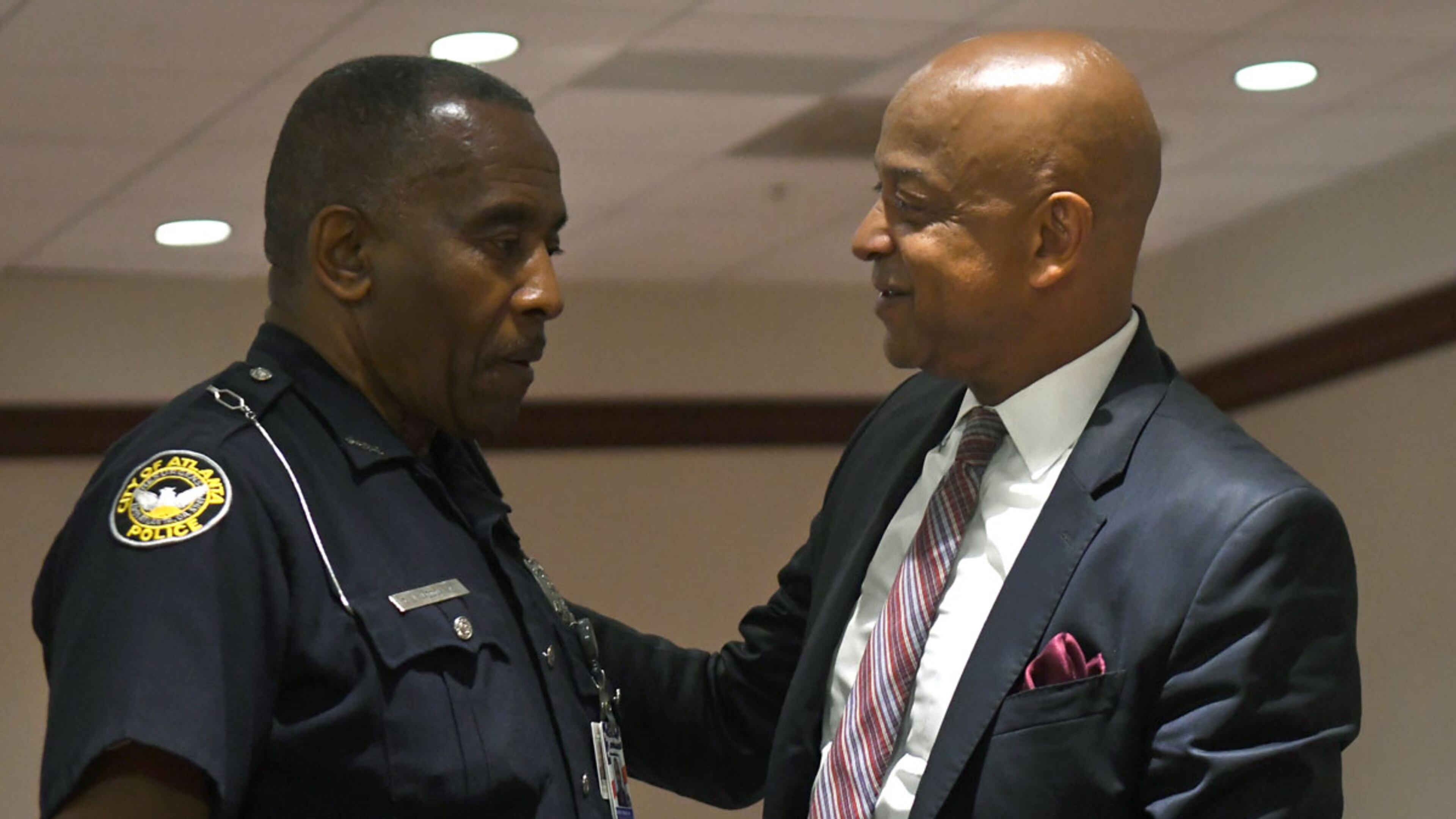 Officer C.J. Maddox Jr. (left) speaks with DeKalb County Sheriff Jeff Mann (right) before Mann pleaded guilty to charges of obstruction and prohibited conduct at Atlanta Municipal Court in Atlanta on Thursday. (REBECCA BREYER)