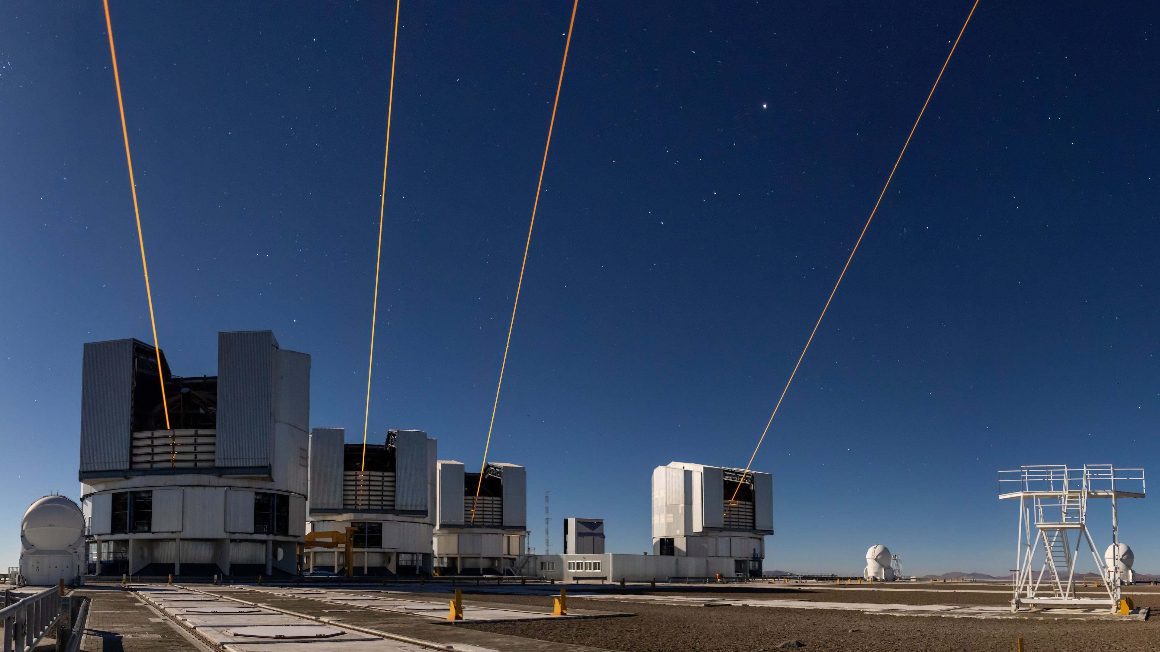 This photo made with a long exposure and released by the European Southern Observatory (ESO) on Nov. 10, 2025, shows four lasers at ESO's Paranal Observatory, each one launched from one of the four eight-meter telescopes on site in Taltal, Chile. (A. Berdeu/European Southern Observatory via AP)