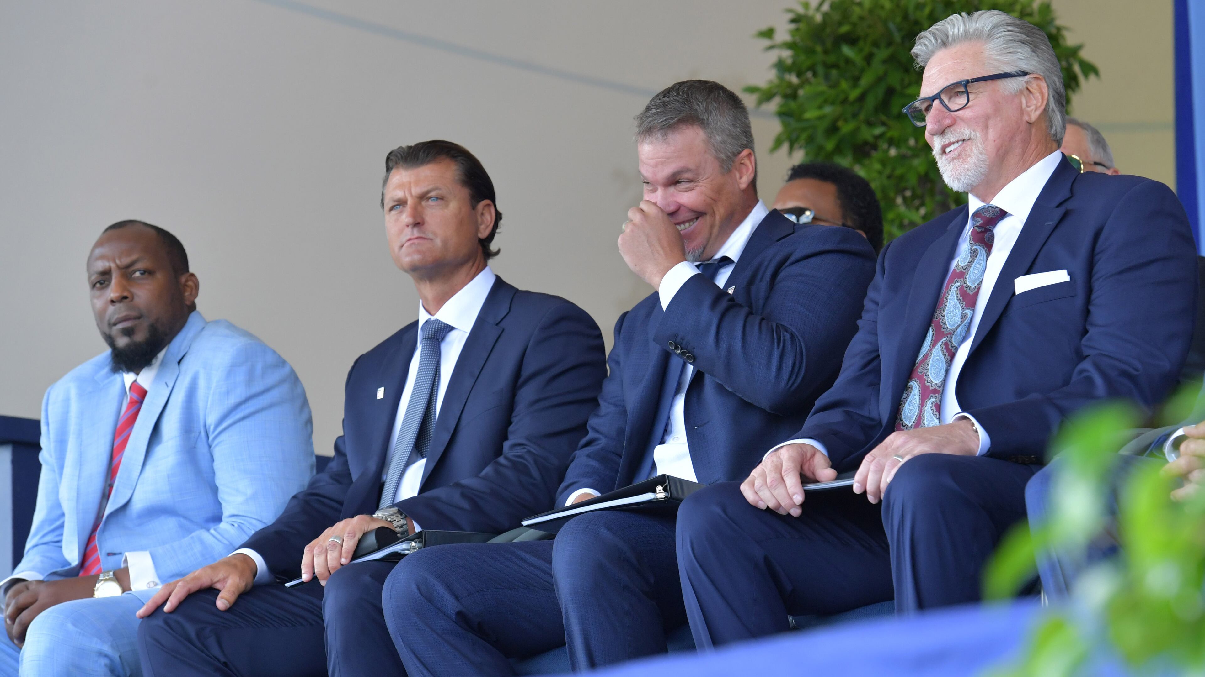 Braves legend Chipper Jones breaks into laughter while listening to speeches along fellow inductees (from left) Vladimir Guerrero, Trevor Hoffman, and Jack Morris Sunday, July 29, 2018, in Cooperstown, N.Y.