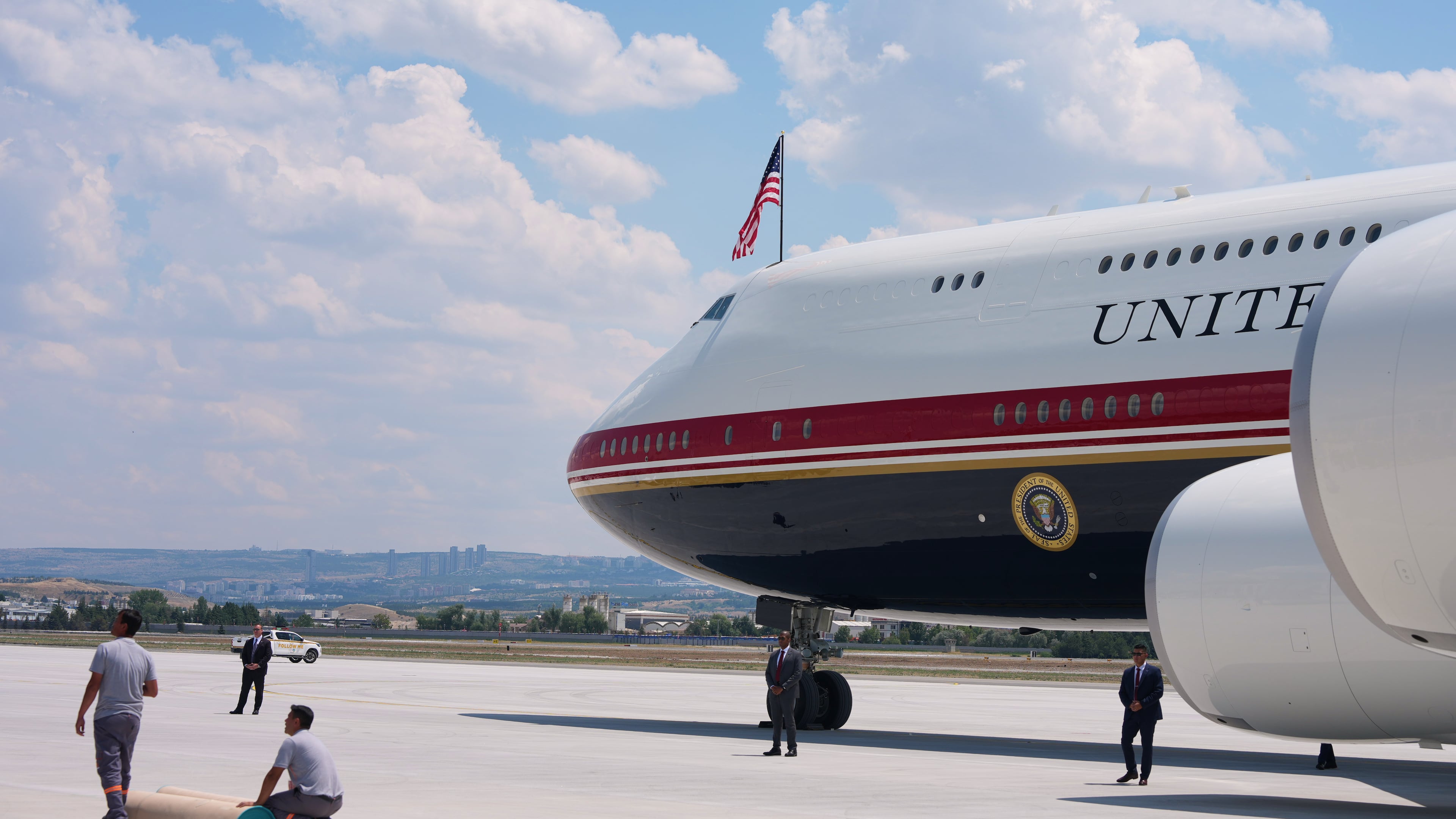 Staff lay a carpet on the tarmac before President Donald Trump exits Air Force One upon arriving for the NATO summit in Ankara, Turkey, Tuesday, July 7, 2026. (AP Photo/Alex Brandon)
