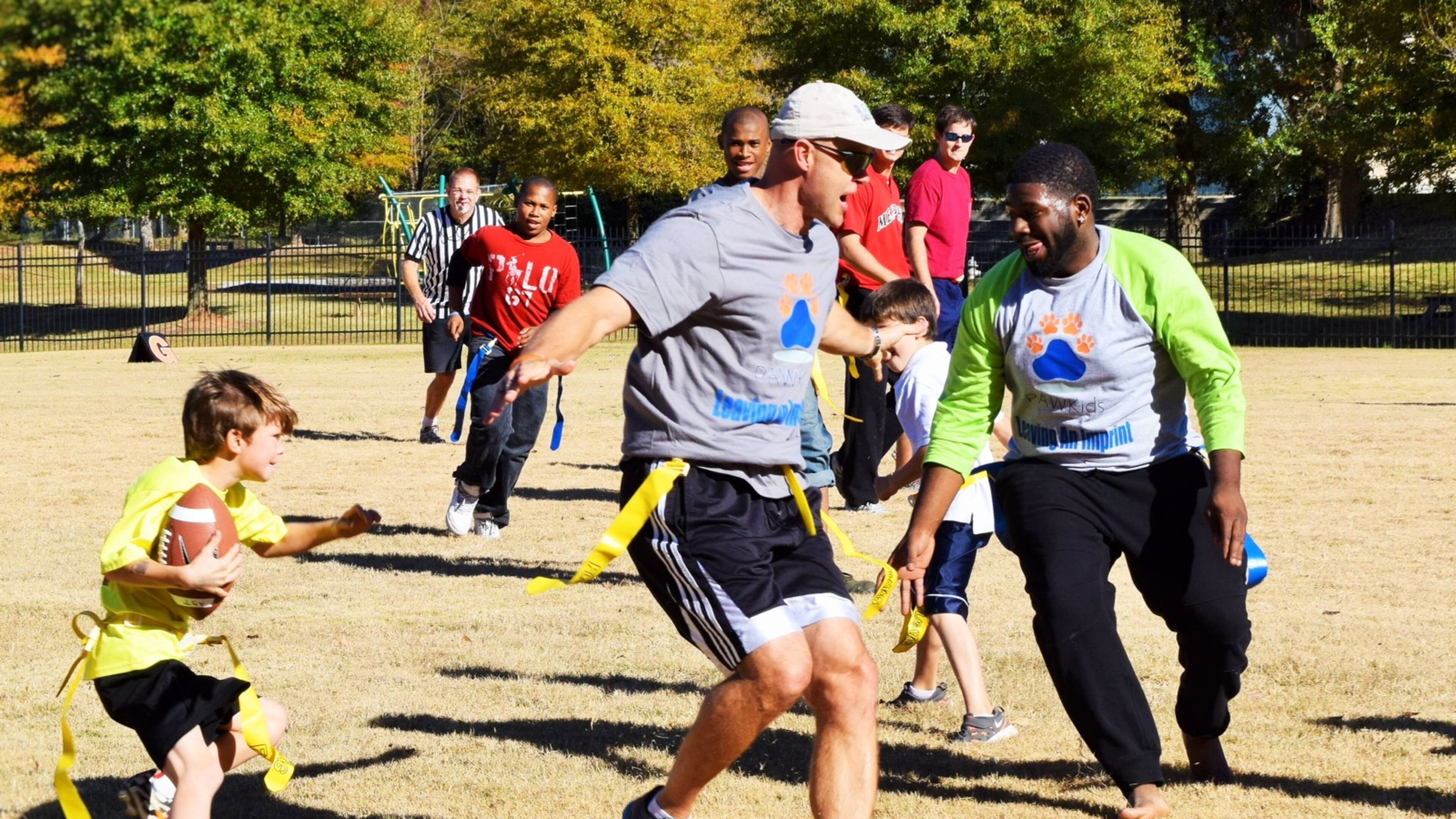 Danny Wuerffel (center) plays flag football with kids in Atlanta. In college, Wuerffel won the Heisman Trophy as quarterback for the Gators. He went on to play for the New Orleans Saints and several other teams in the NFL. CONTRIBUTED