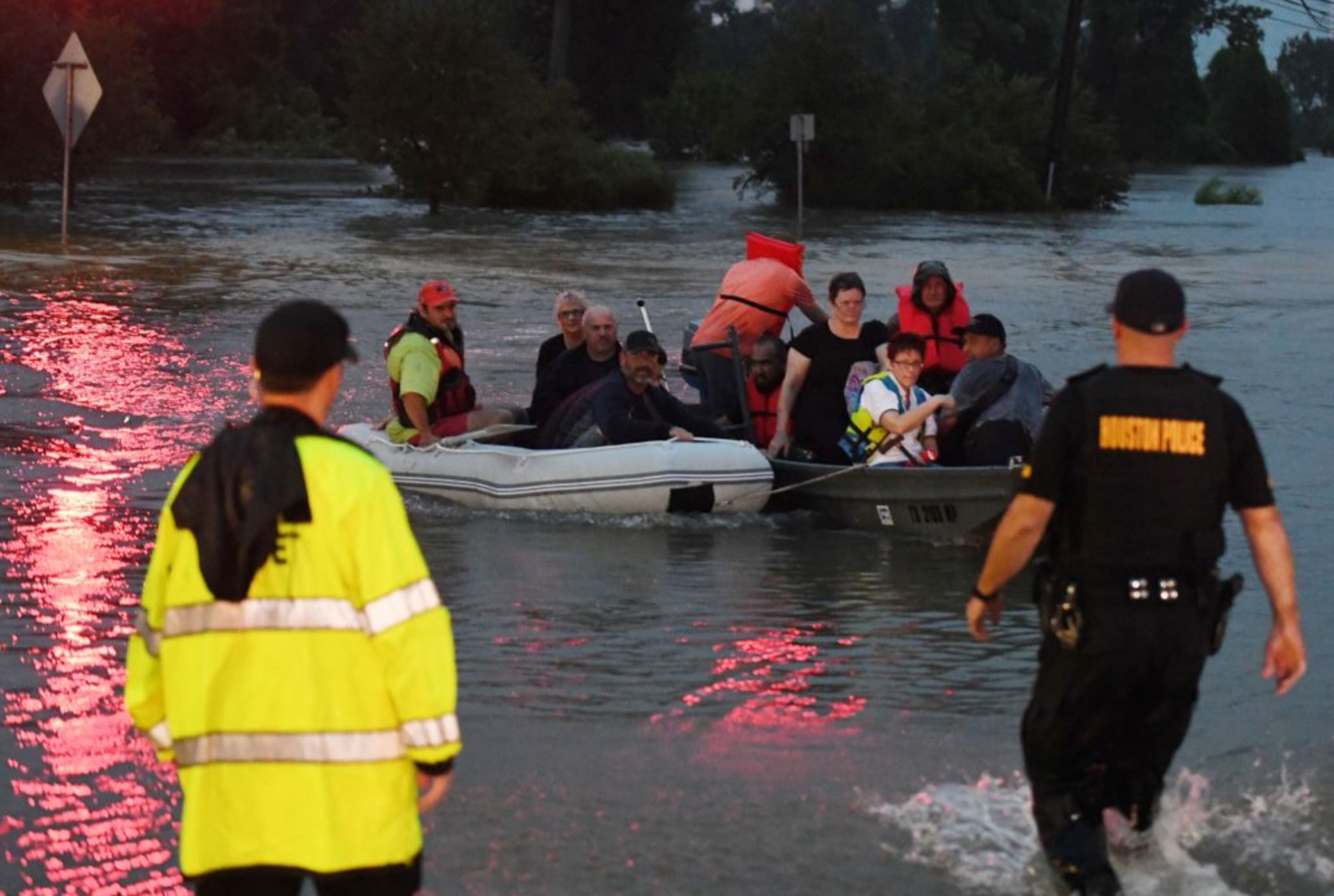 People are rescued from a hotel by boat after Hurricane Harvey caused heavy flooding in Houston, Texas on August 27, 2017.
Massive flooding unleashed by deadly monster storm Harvey left Houston -- the fourth-largest city in the United States -- increasingly isolated as its airports and highways shut down and residents fled homes waist-deep in water.