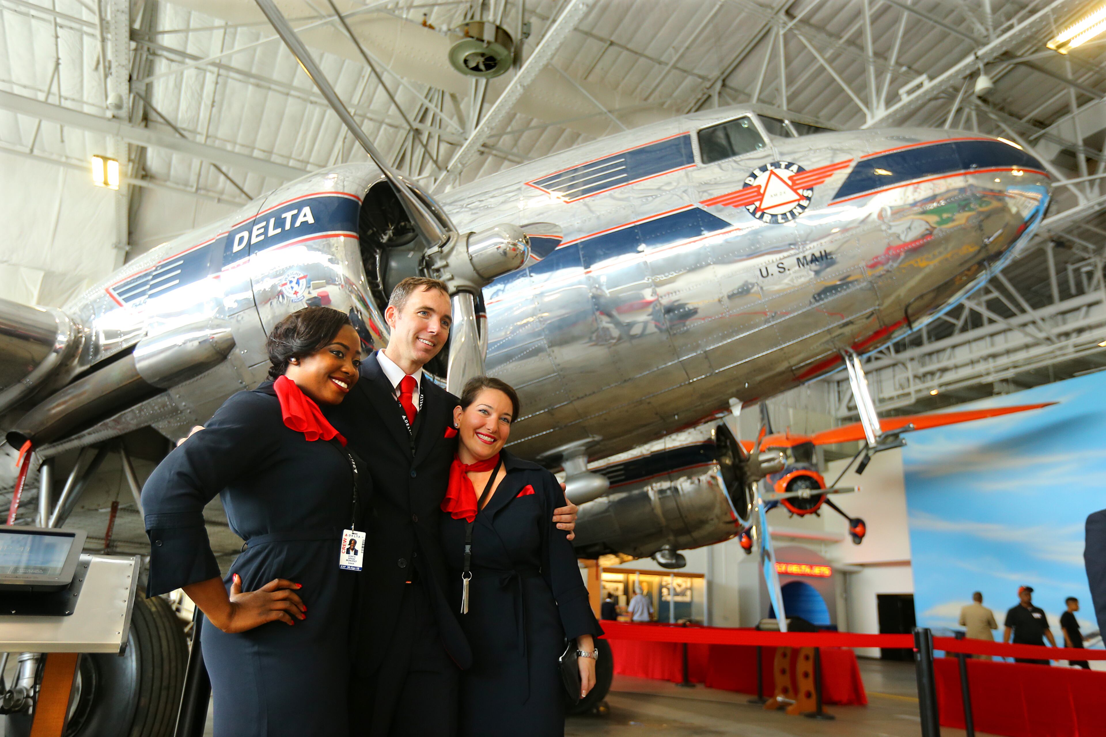 061214 ATLANTA: Delta flight crew members Donta Moncrief (from left), Jake Jesse, and Rachelle Naimi have their picture taken with the Douglas DC-3 Ship 41 on display at the Delta Flight Museum on Thursday, June 12, 2014, in Atlanta. The iconic DC-3's spreed, range and passenger capacity made the airlines profitable. Ship 41 is the only remaining Delta passenger DC-3. CURTIS COMPTON / CCOMPTON@AJC.COM