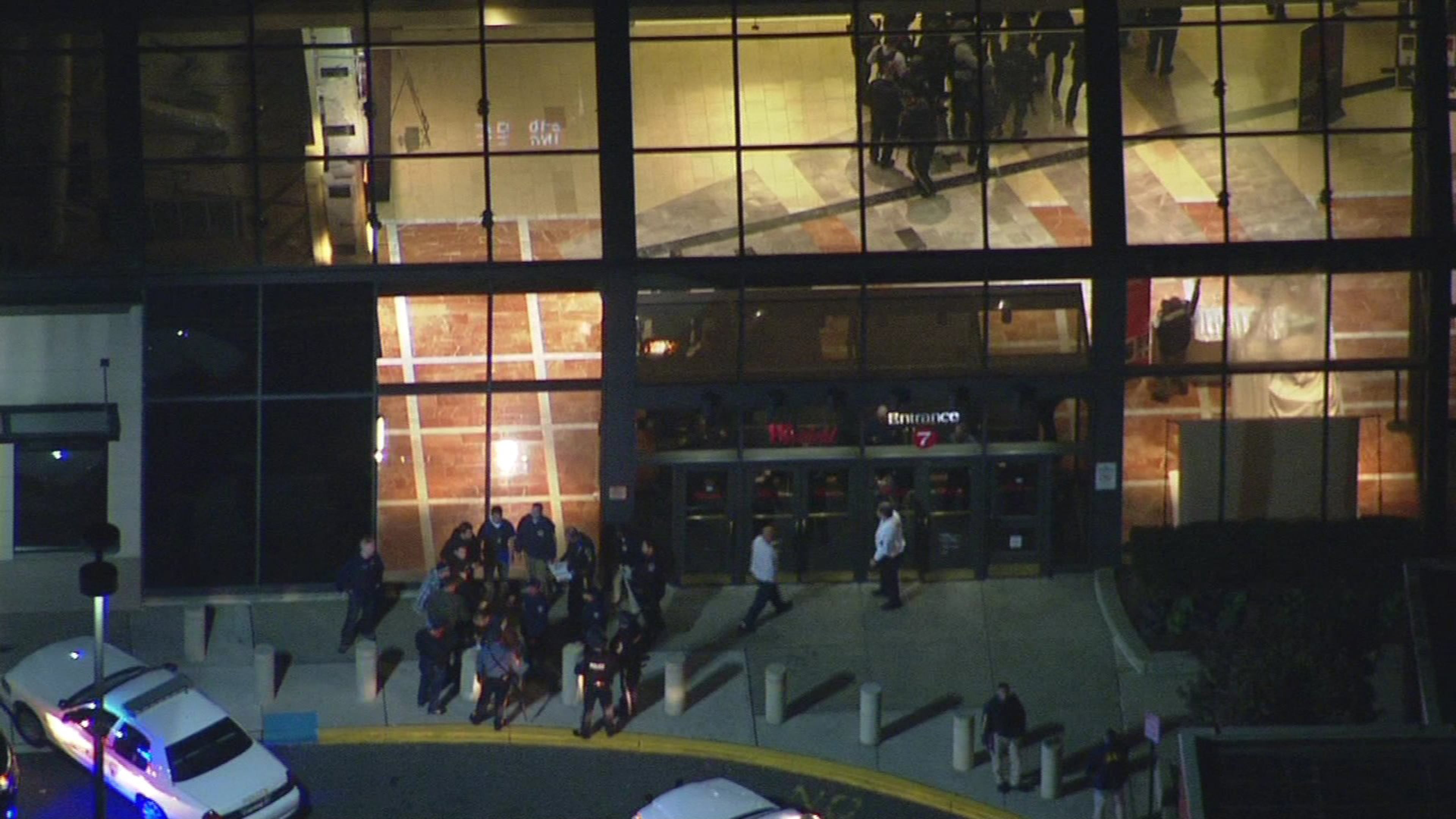 In this image provided by News 12 New Jersey, authorities work the scene at Garden State Plaza Mall, late Monday, Nov. 4, 2013, in Paramus, N.J., after there were reports of multiple shots being fired inside the mall. (AP Photo/News 12 New Jersey)