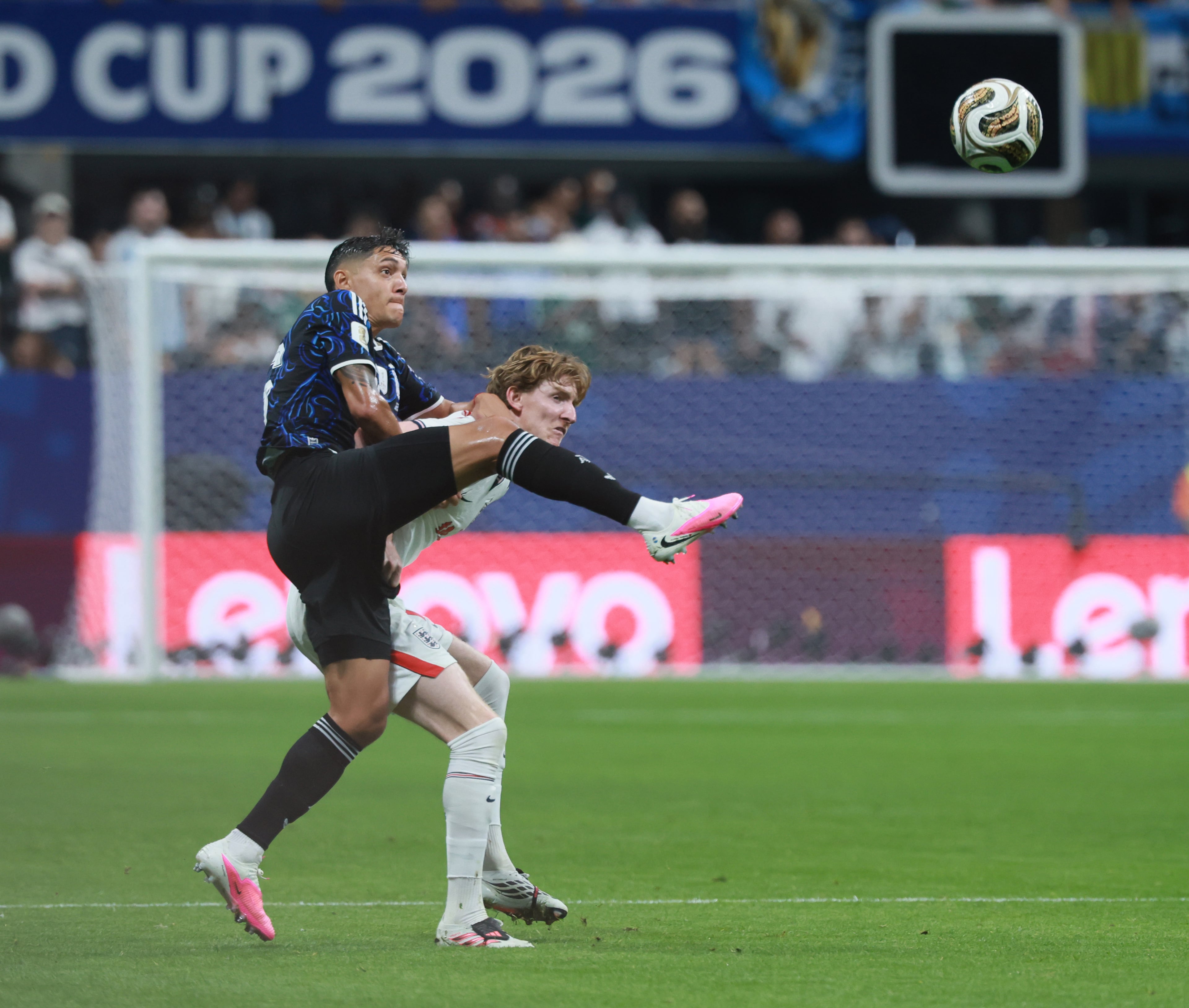 Argentina's Nahuel Molina, left, battles England's Anthony Gordon during first half of Argentina vs. England FIFA World Cup Semifinal match at Atlanta Stadium (Mercedes-Benz Stadium) on Wednesday, July 15, 2026. (Jason Getz/AJC)