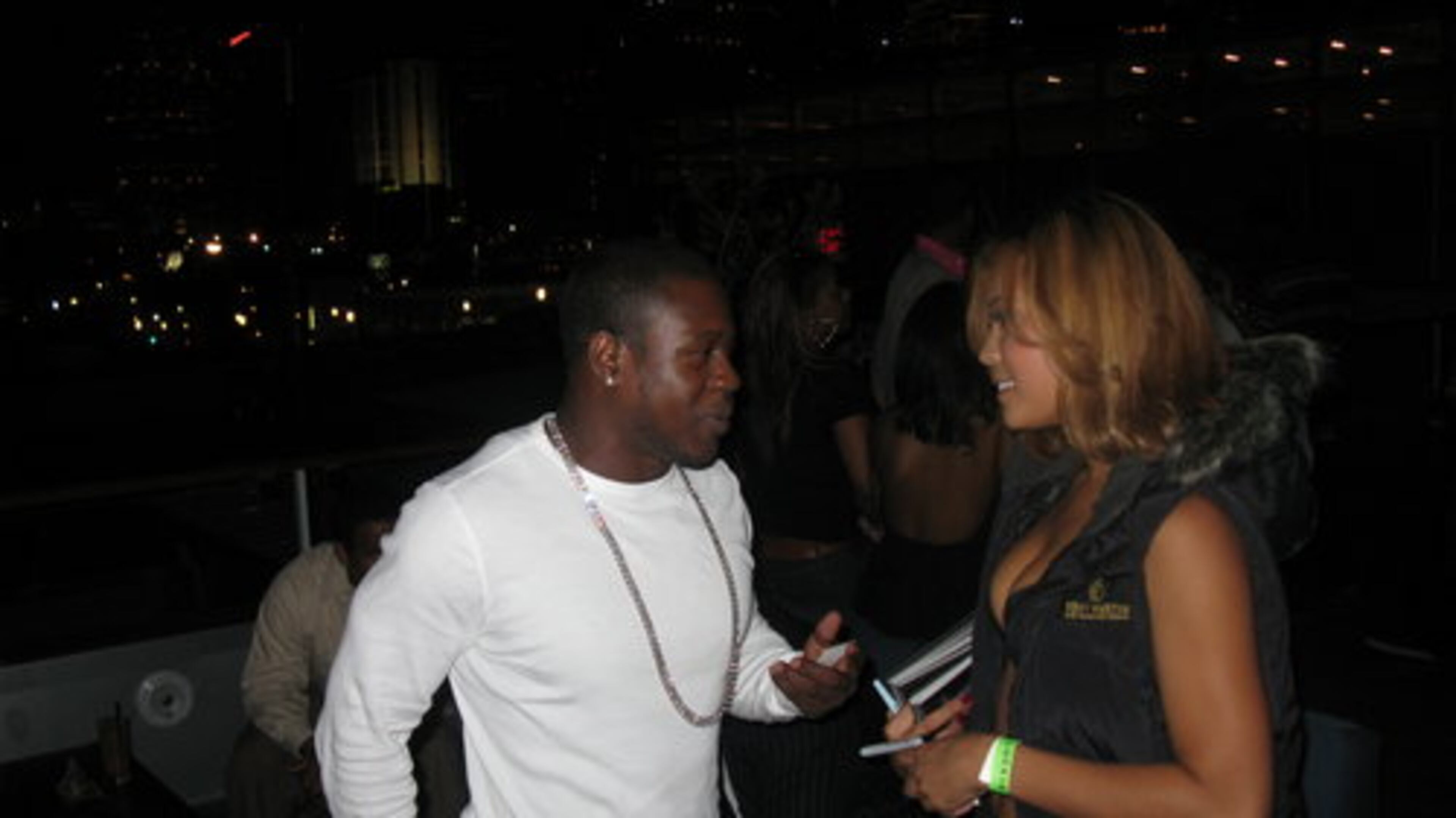 Personal trainer Jarvis Bowman speaks with a "Remy Girl." The cognac brand sponsored the event.