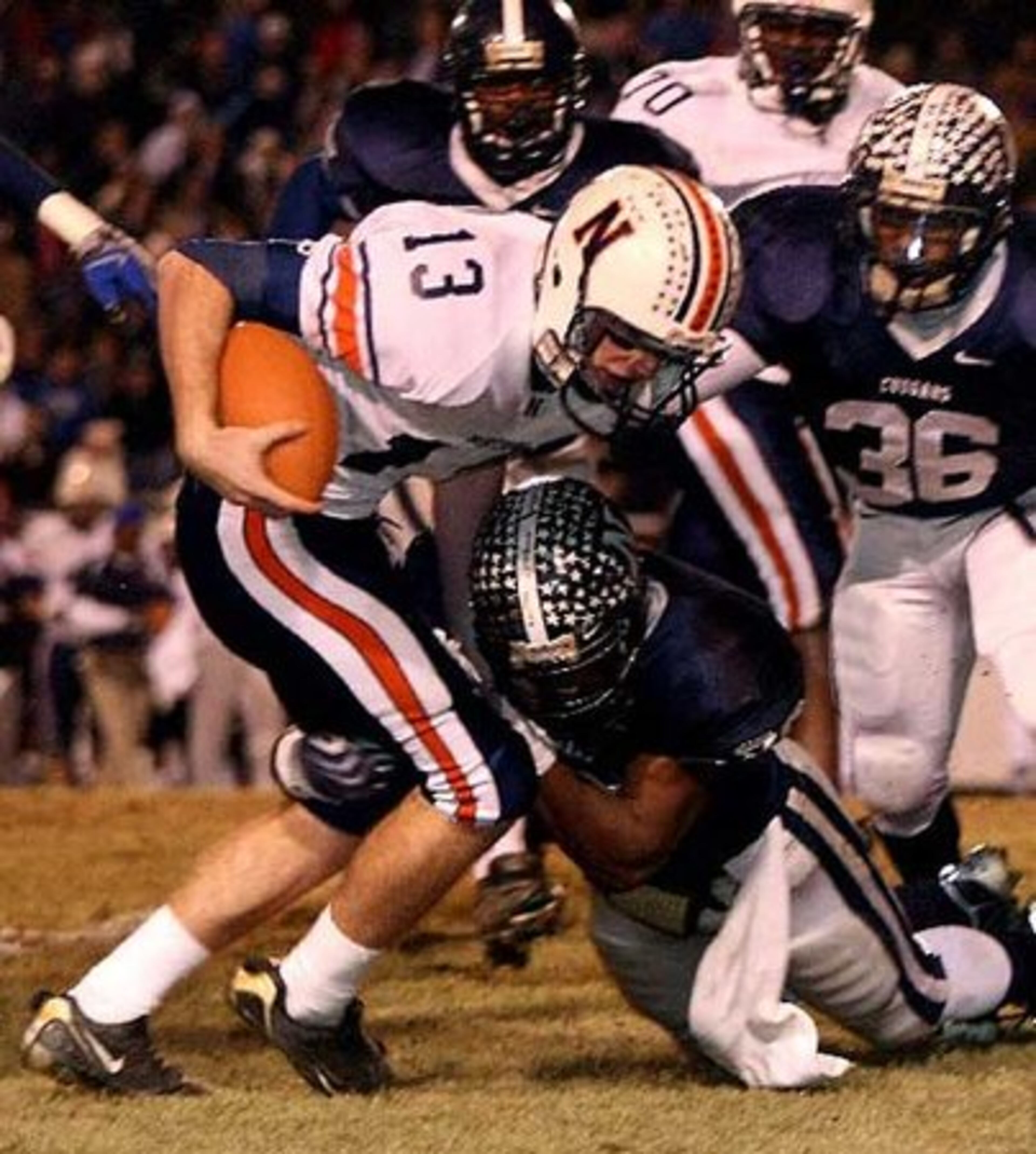 Northside-Warner Robins quarterback Briar Van Brunt (13) can't get past Newnan's Alec Ogletree (39).