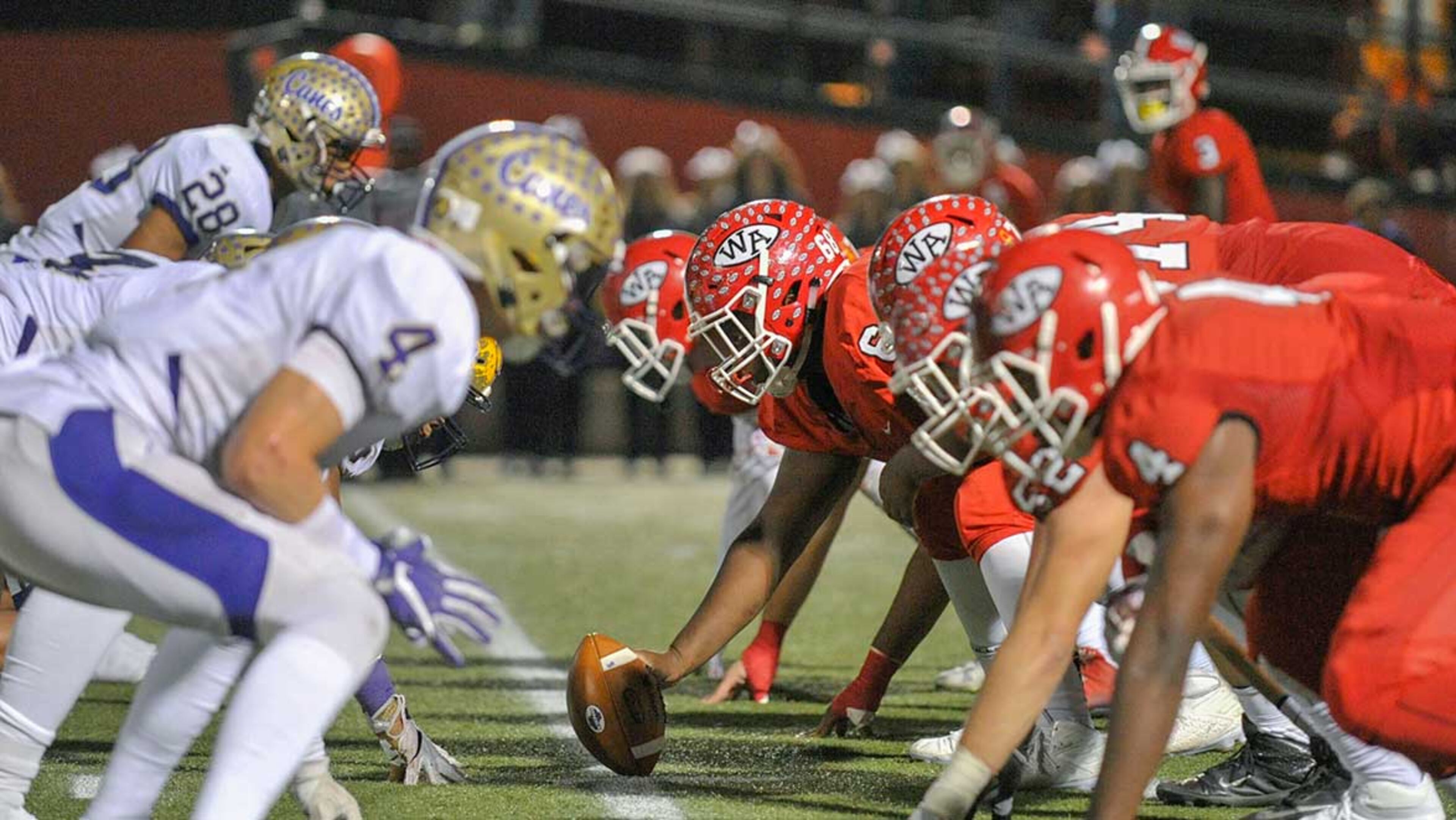 Cartersville and Woodward Academy prepare for a play during Friday's game.
