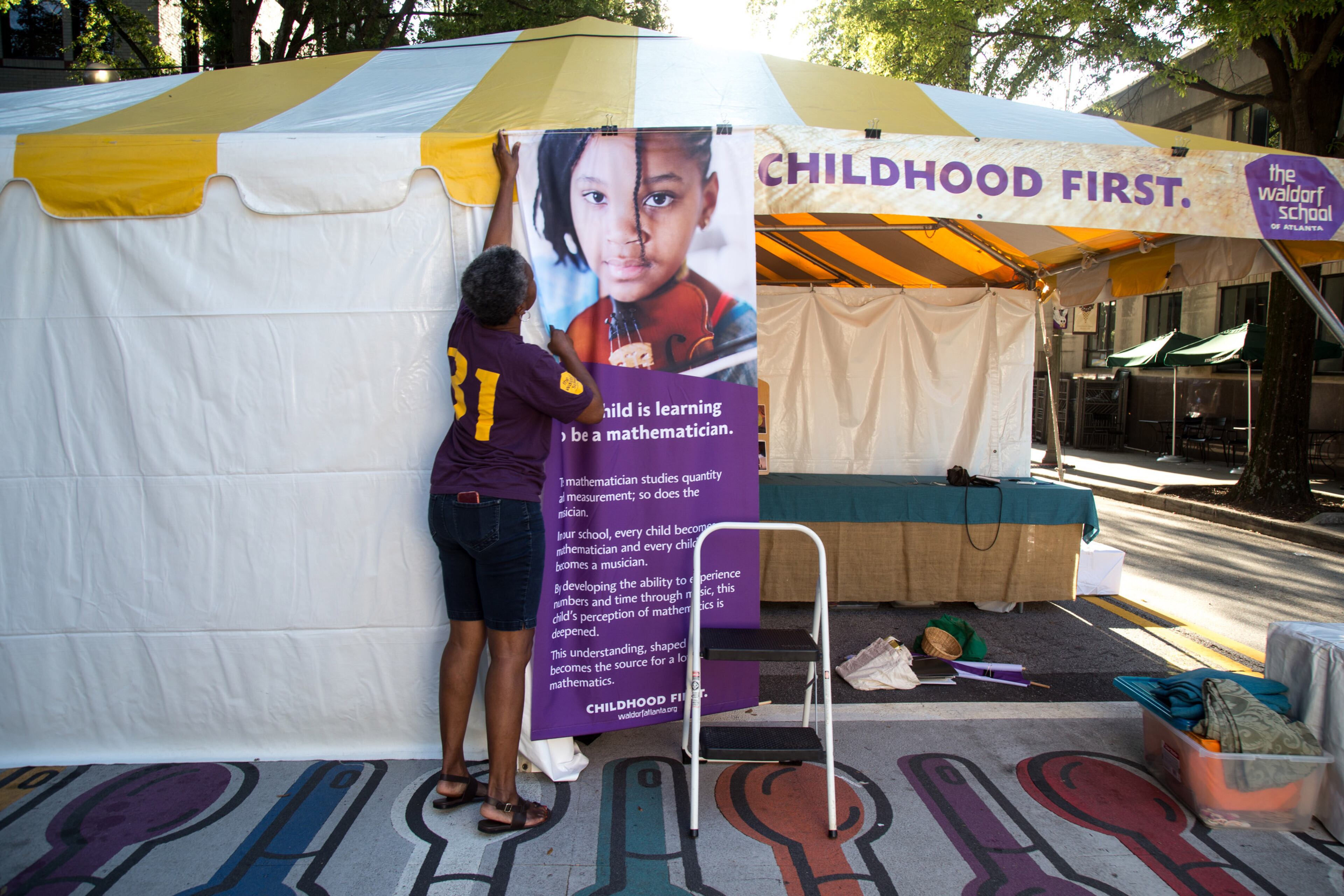 Stacey Alston from the Waldorf School of Atlanta gets her booth ready before Saturday's start of the AJC Decatur Book Festival on September 1, 2018. The festival kicked off Friday night and continues Sunday. (Photo: STEVE SCHAEFER / SPECIAL TO THE AJC)