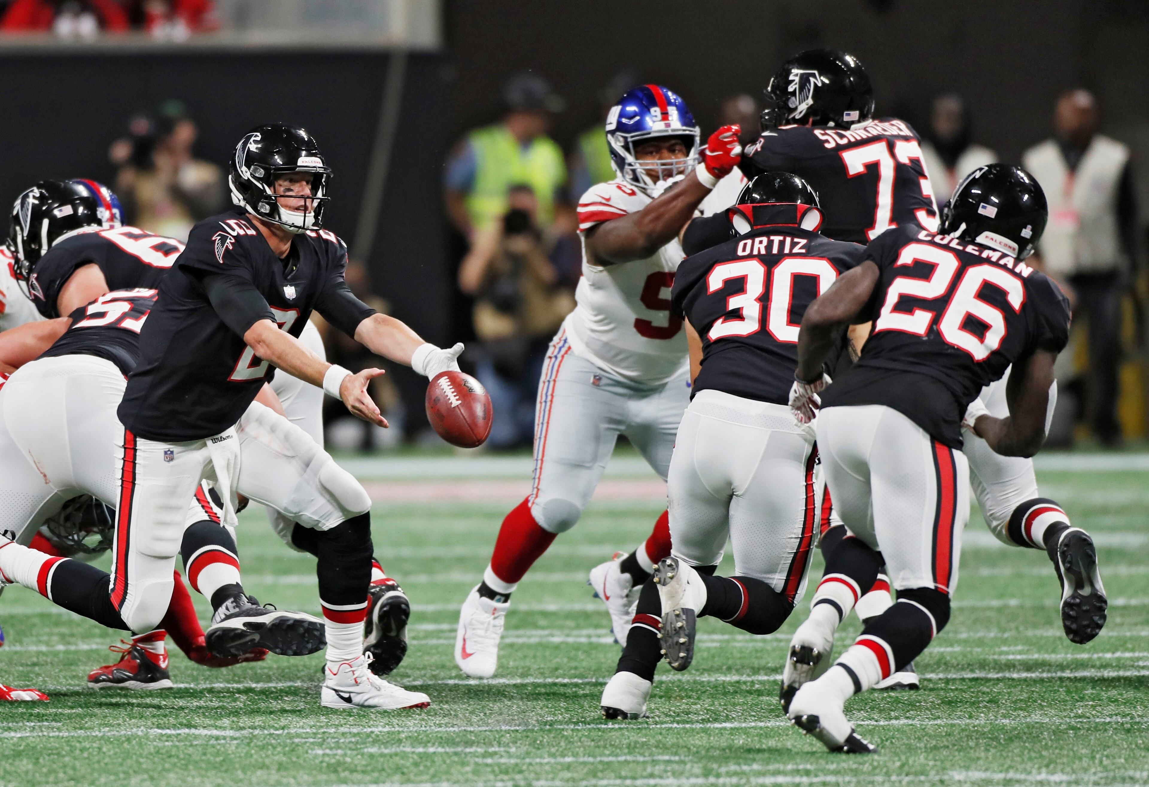 10/22/18 - Atlanta - Atlanta Falcons quarterback Matt Ryan (2) tosses to Atlanta Falcons running back Tevin Coleman (26) who ran it in for a touchdown. The Atlanta Falcons played the New York Giants in an NFL football game Monday, October 22, 2018, at Mercedes-Benz Stadium in Atlanta, GA. BOB ANDRES / BANDRES@AJC.COM