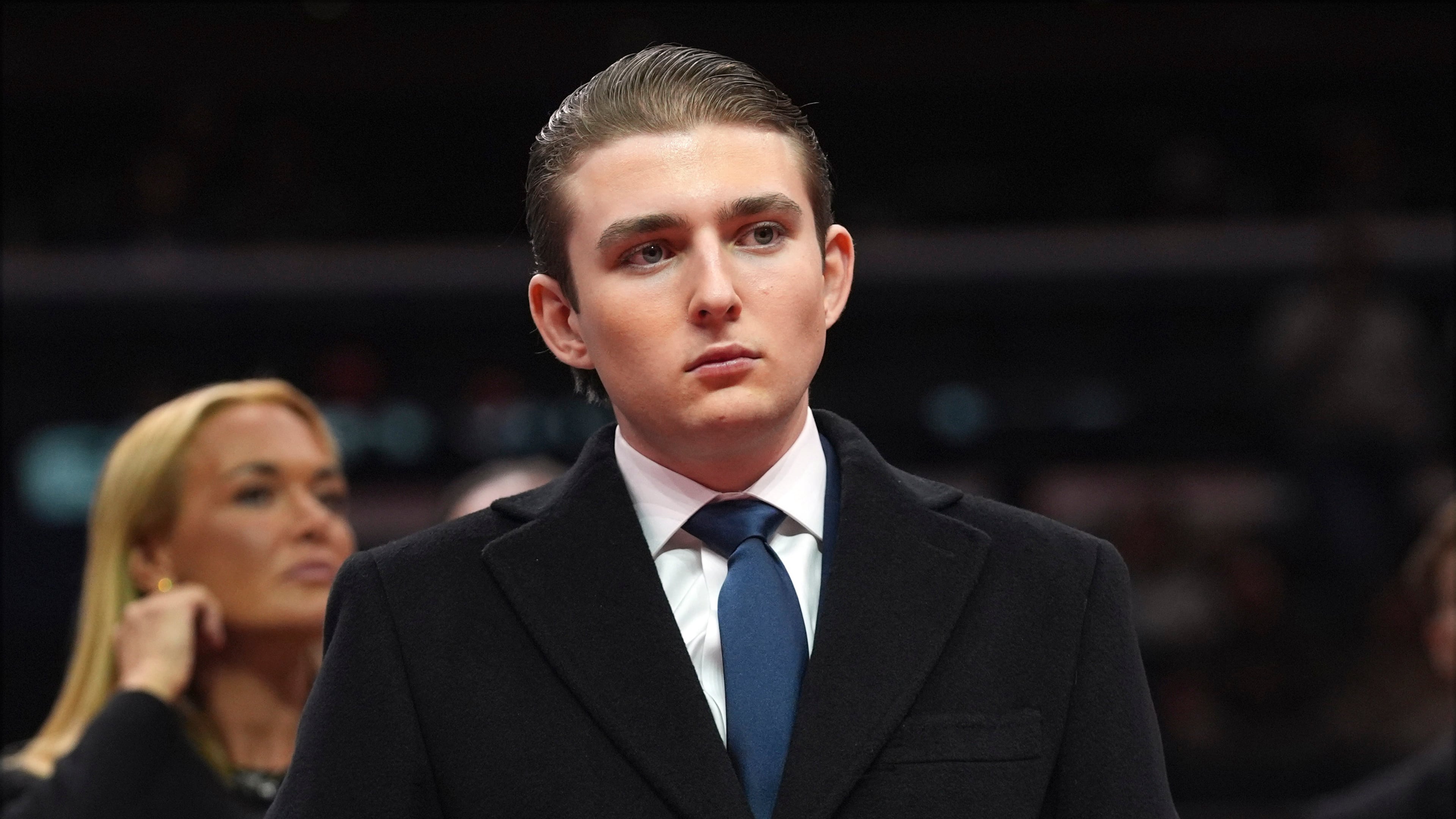 FILE - Barron Trump watches as his father, President Donald Trump attends an indoor Presidential Inauguration parade event at Capital One Arena, in Washington, Jan. 20, 2025. (AP Photo/Evan Vucci, File)
