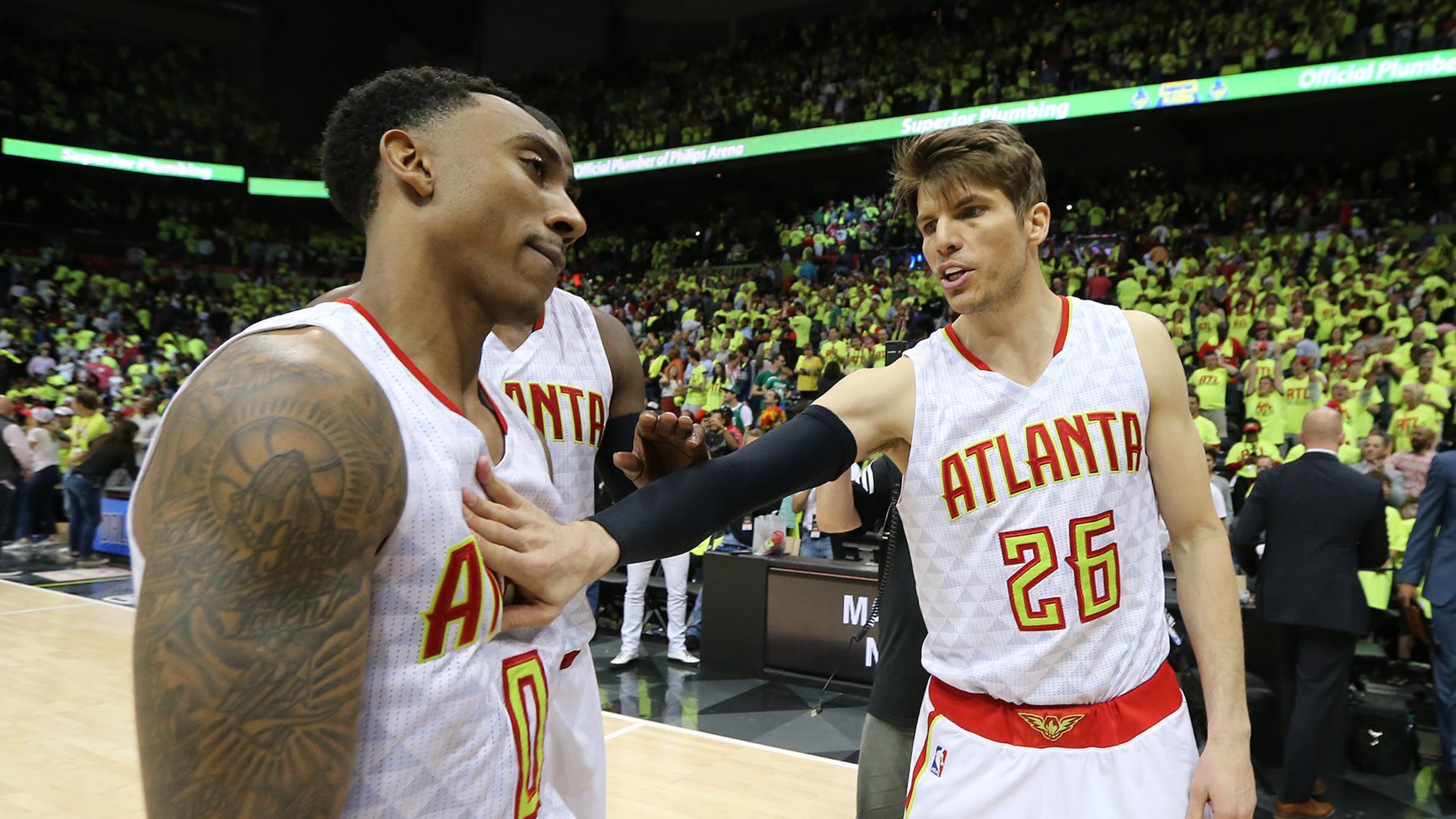 Jeff Teague (left) gets a pat on the chest from Kyle Korver as the Hawks beat the Celtics 102-101 in Game 1 of their NBA Eastern Conference first round playoff game at Philips Arena on Saturday, April 16, 2016. (Curtis Compton/AJC)