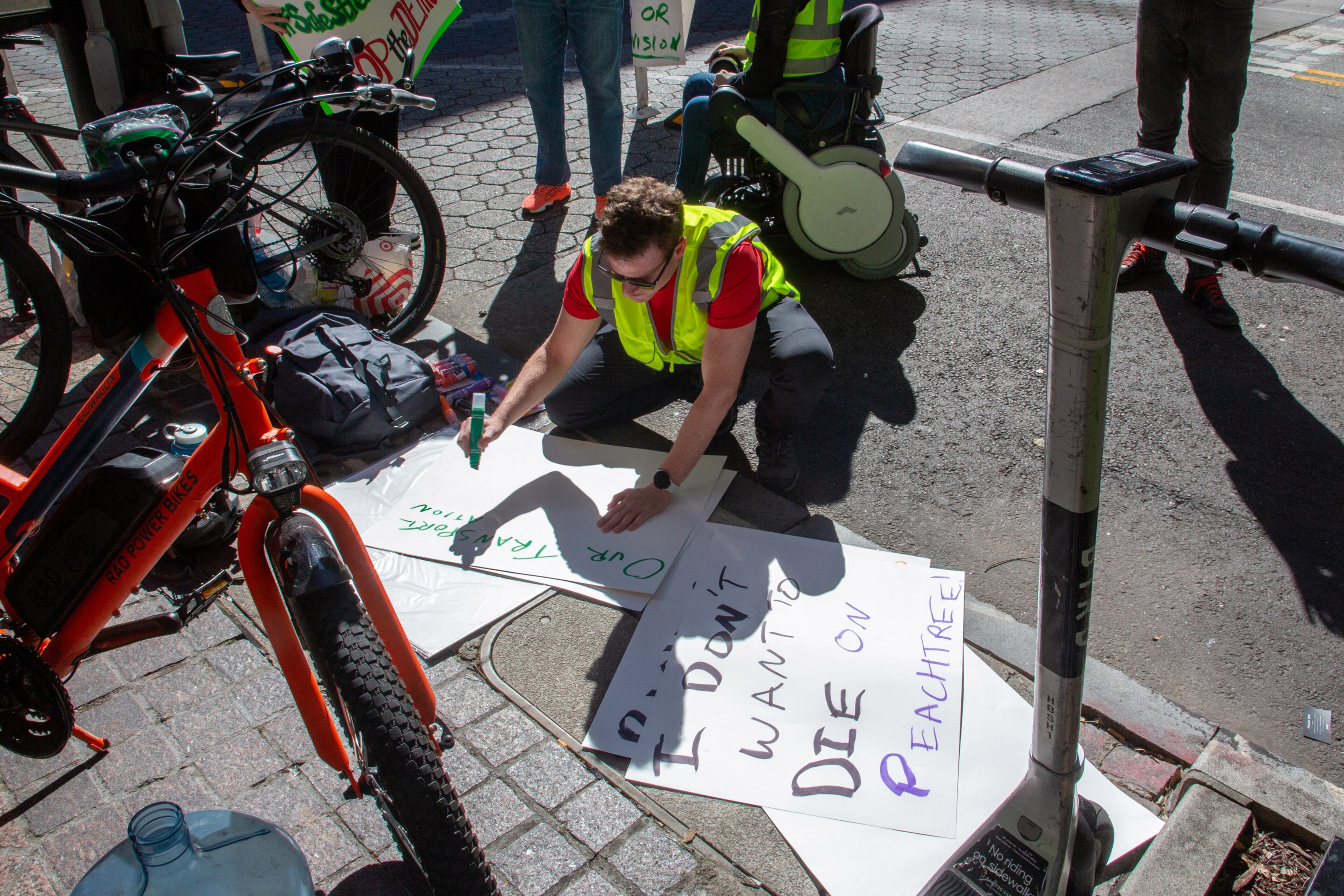 Michael Handelman makes up signs before the start of a protest of the removal of the 'shared streets' in Atlanta Monday, March 14, 2022. STEVE SCHAEFER FOR THE ATLANTA JOURNAL-CONSTITUTION