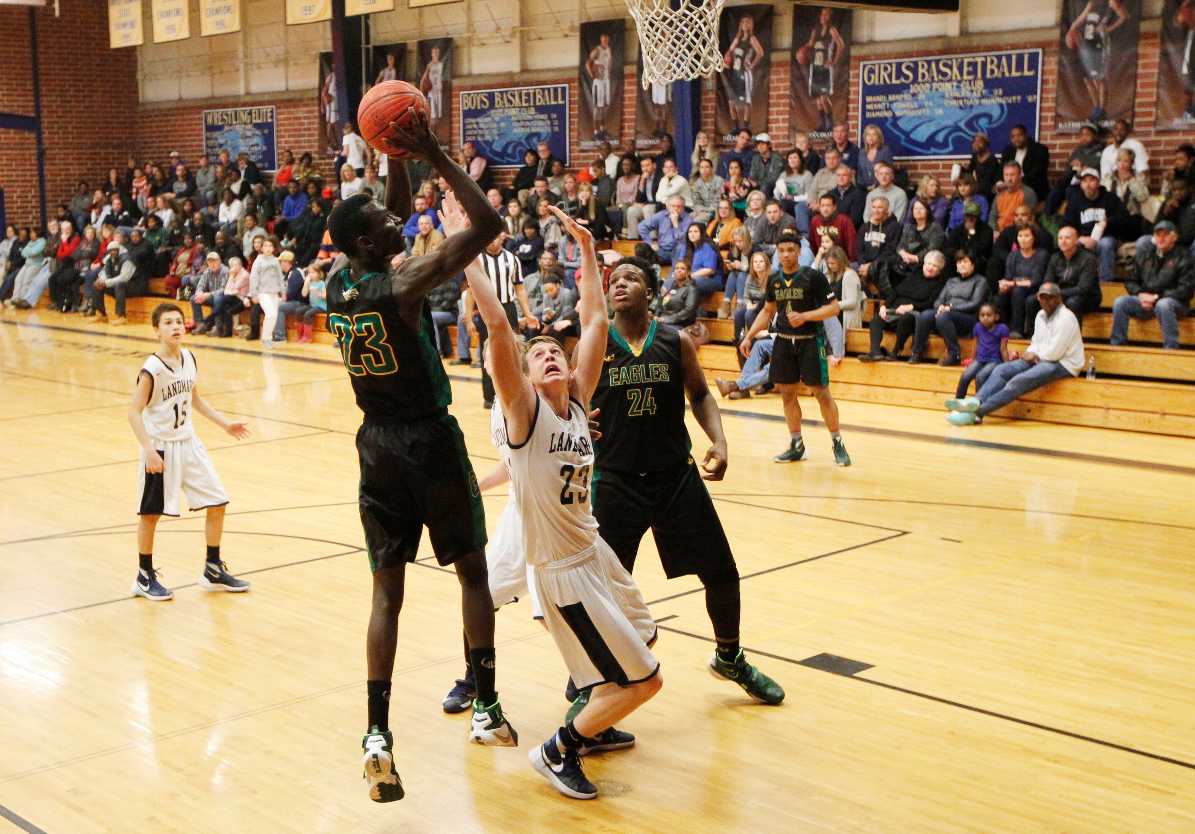 Greenforest Christian forward Abayomi Iyiola (23-L) shoots under the basket against Landmark Christian forward Wix Patton (23-C) as teammate Mohammed Abdulsalem looks on during their game at a high school basketball game at Landmark Christian school Friday, February 5, 2016. TAMI CHAPPELL/SPECIAL TO THE AJC
