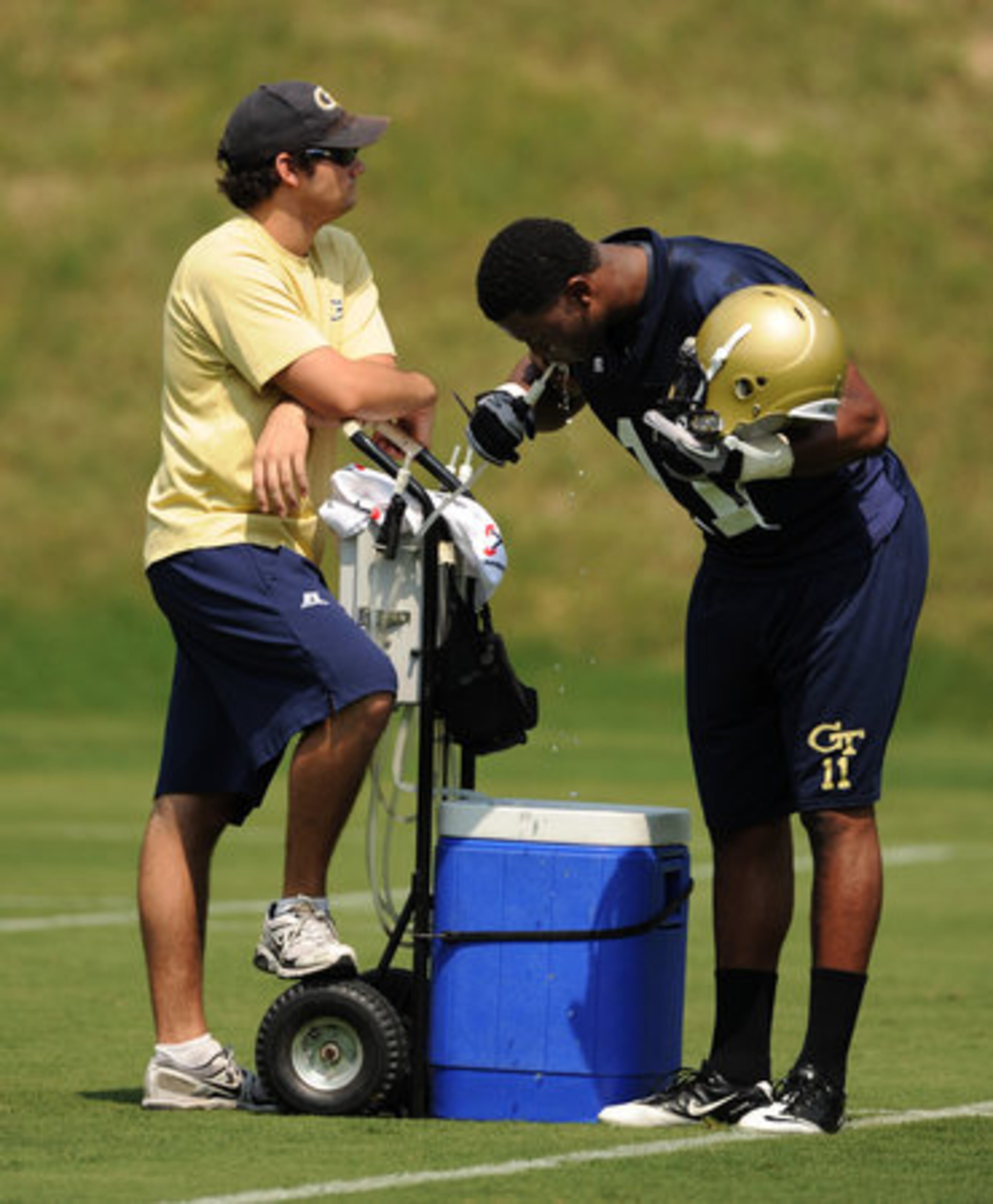 Tech players were forced to deal with the heat -- in the high 90s -- for the first day of practice. Linebacker Brandon Watts gets some water.