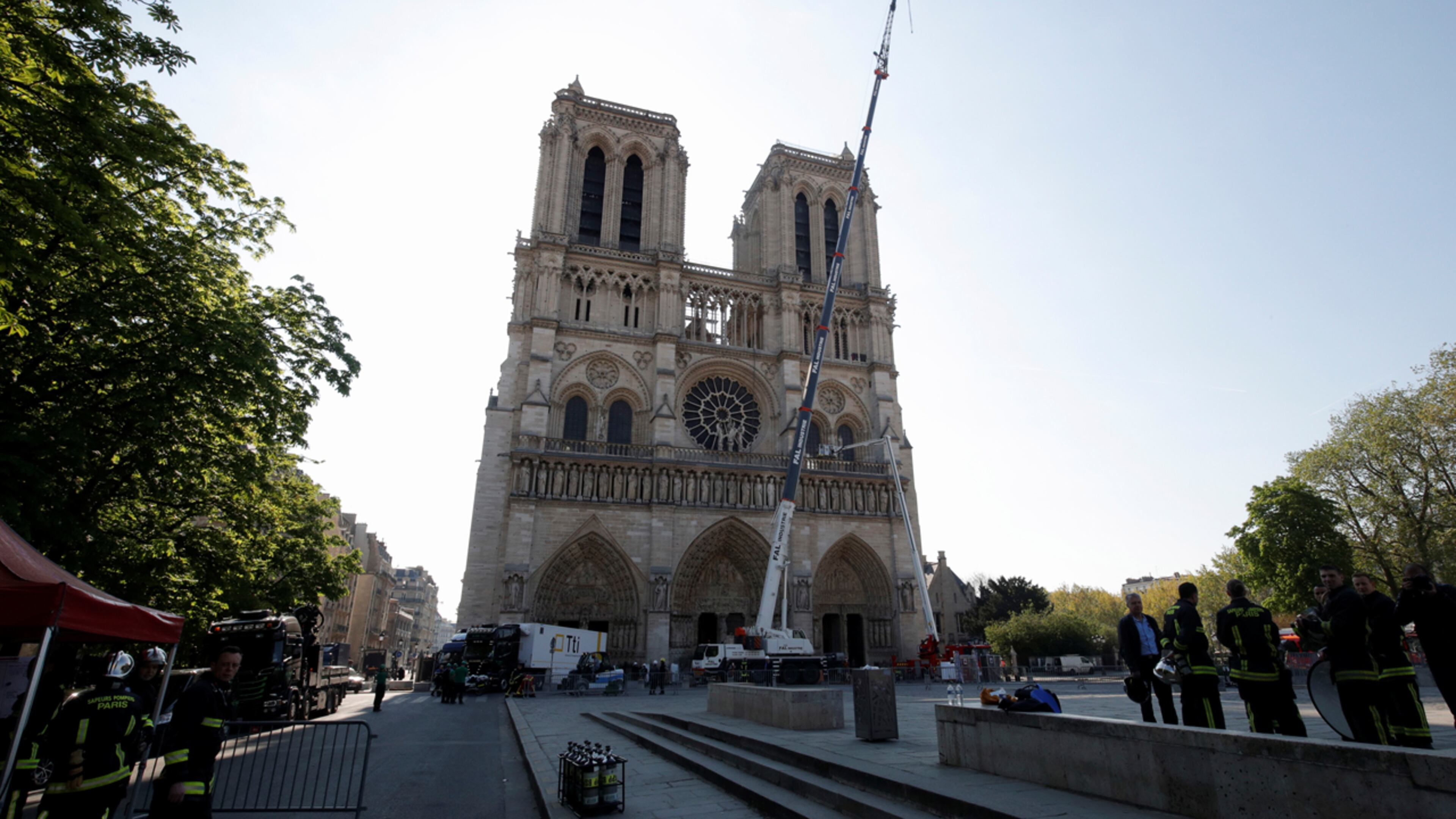 A crane works at Notre-Dame cathedral in Paris, Friday, April 19, 2019. Rebuilding Notre Dame, the 800-year-old Paris cathedral devastated by fire this week, will cost billions of dollars as architects, historians and artisans work to preserve the medieval landmark.