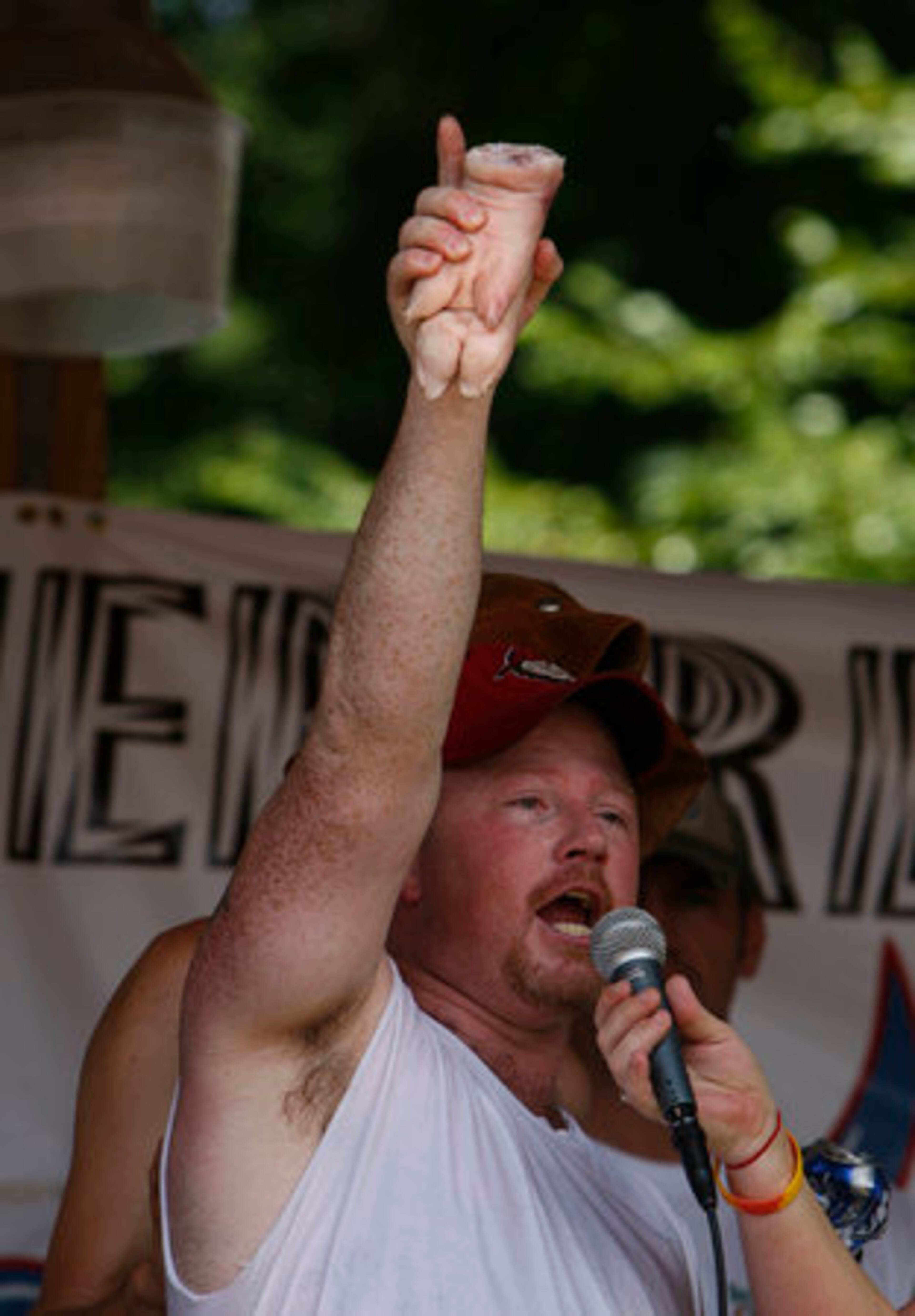 Eric Outler holds up the pig feet that won him the pig feet bobbing championship.