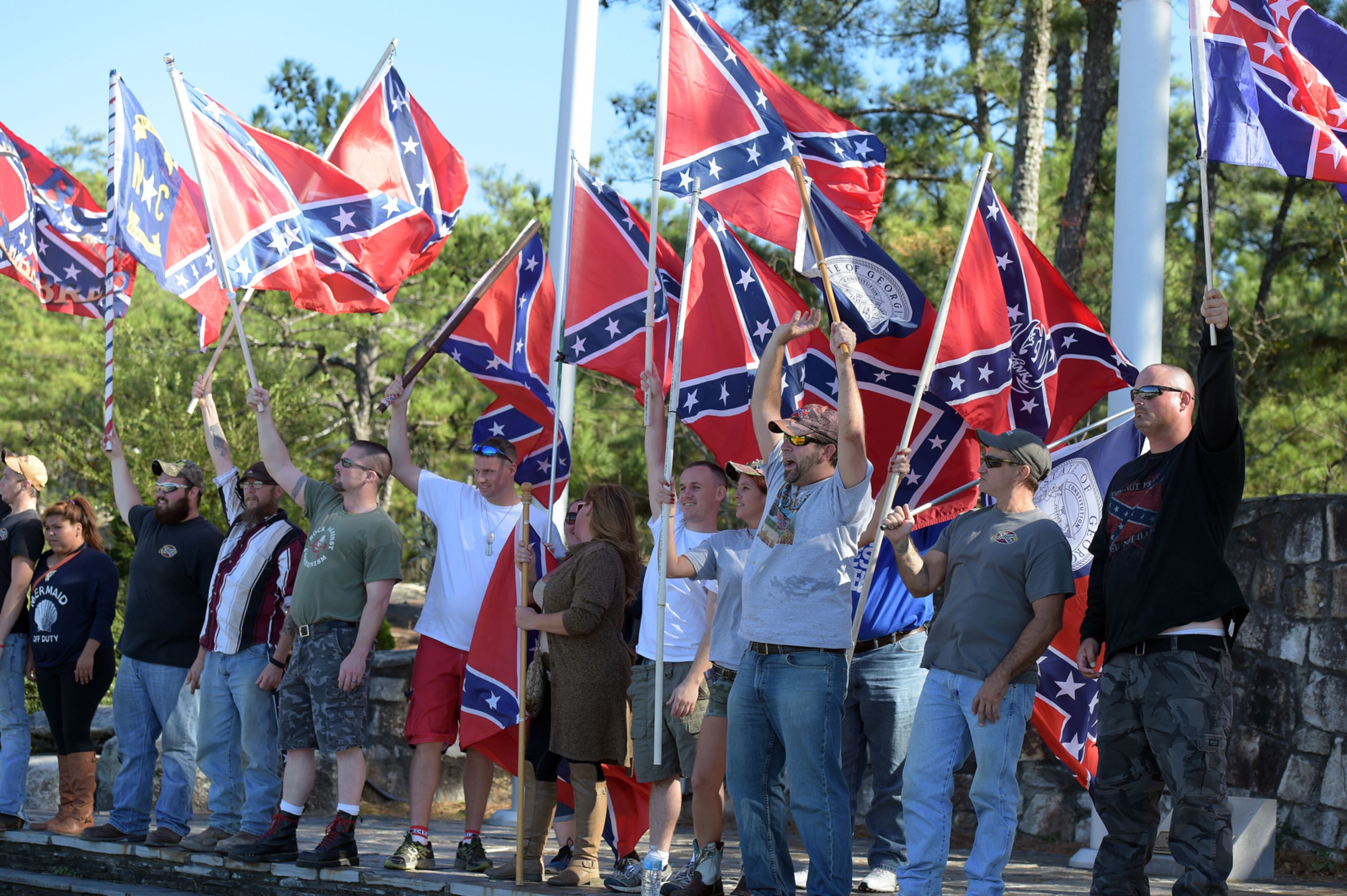 PROTEST ON THE MOUNTAIN--NOVEMBER 15, 2015 STONE MOUNTAIN Pro-Confederate flag supporters pose before they head up the mountain on the walk up trail during a protest at Stone Mountain, Saturday, November 14, 2015, after a proposal was made to place a monument on top of it dedicated to Martin Luther King Jr. At noon about 50 protesters and no counter-protesters had arrived. KENT D. JOHNSON/KDJOHNSON@AJC.COM